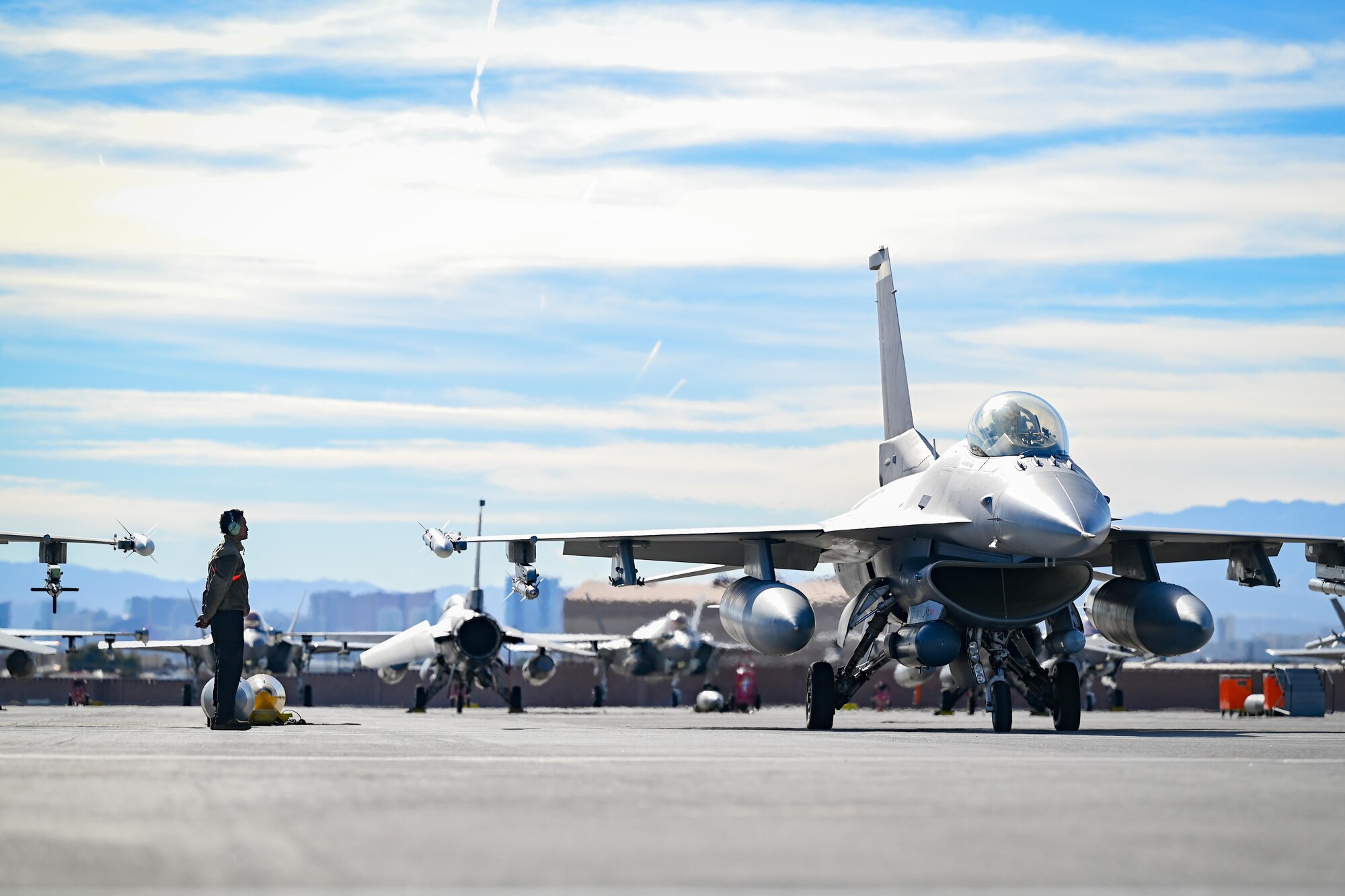 A crew chief marshals an aircraft prior to takeoff.