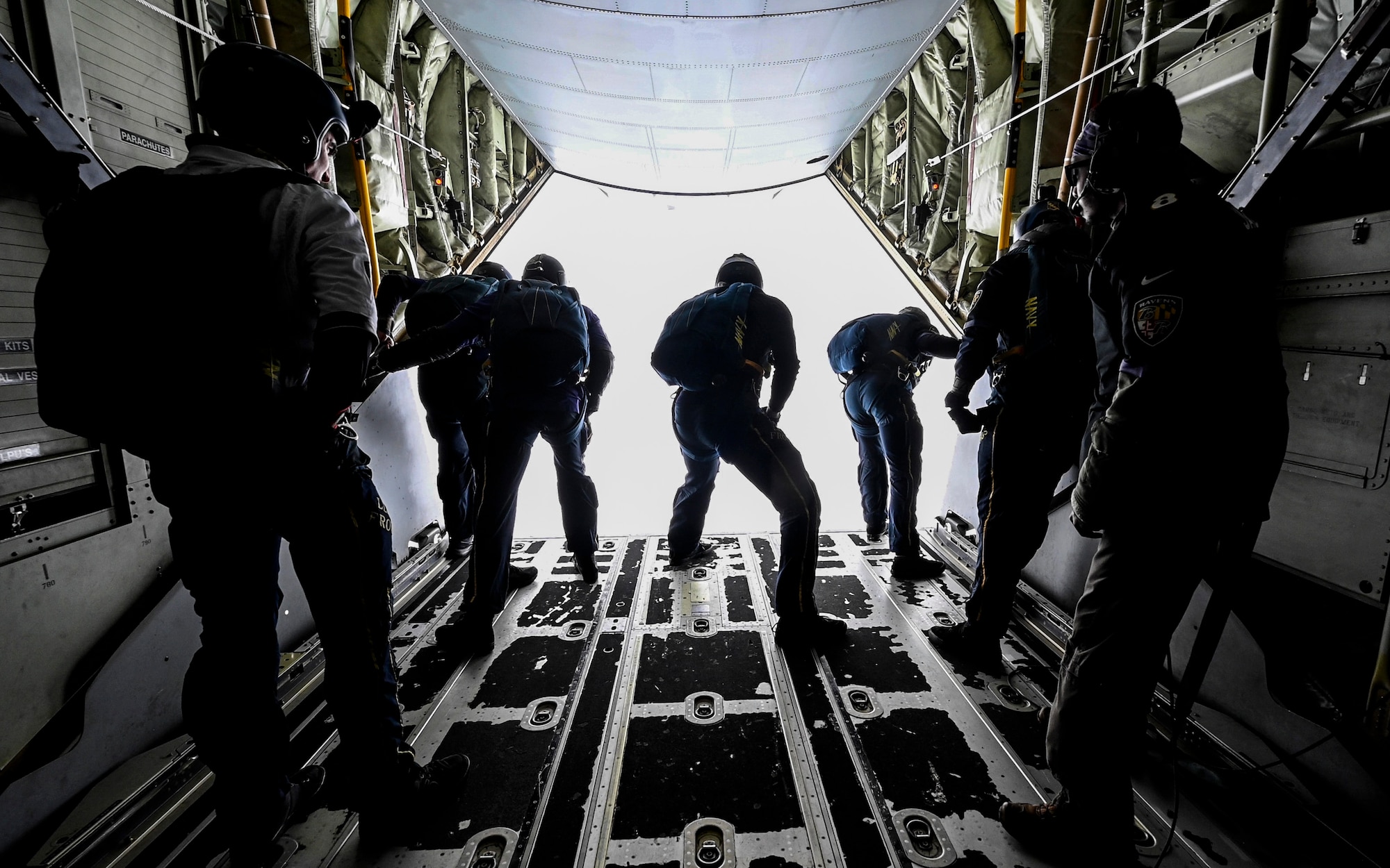 Men look out of an airplane.