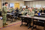 Capt. JD Crinklaw, commander, Puget Sound Naval Shipyard & Intermediate Maintenance Facility, speaks to SurgeMain Sailors Jan. 7, 2023, at Naval Base Kitsap’s Olympic Lodge Training Center, in Bremerton, Washington. His briefing helped kick off the start of "DEPLOYEX24," a two-week deployment exercise, utilizing over 110 Navy Reservist's for PSNS & IMF'S six areas of responsibility. (U.S Navy photo by Wendy Hallmark)