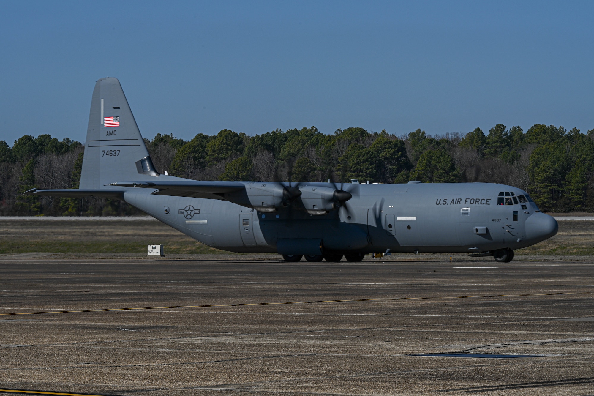 A C-130 taxis on the flightline.