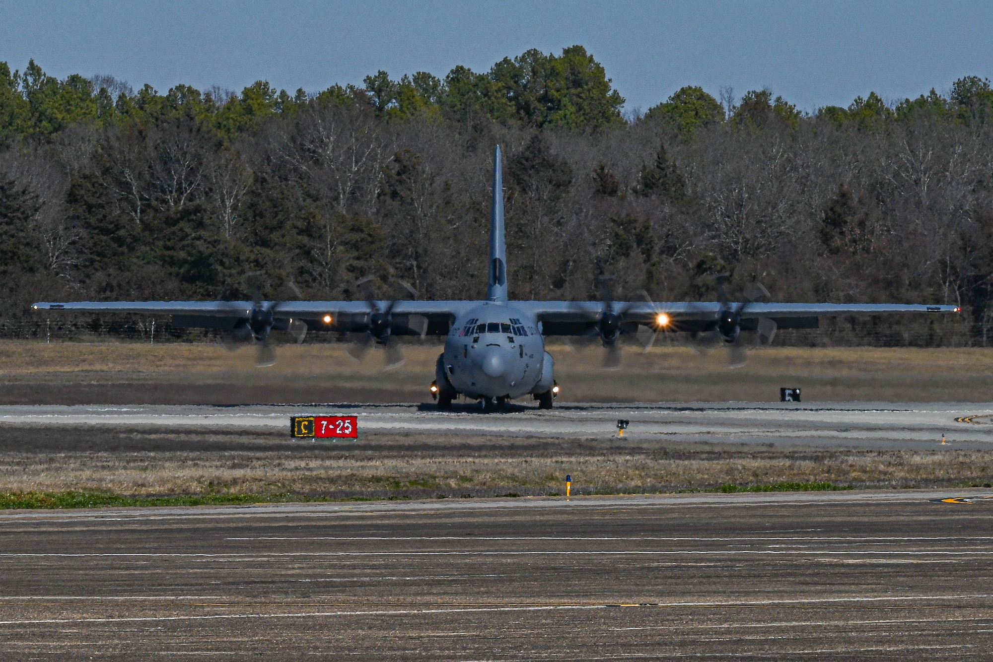 A C-130 taxis on the flightline.