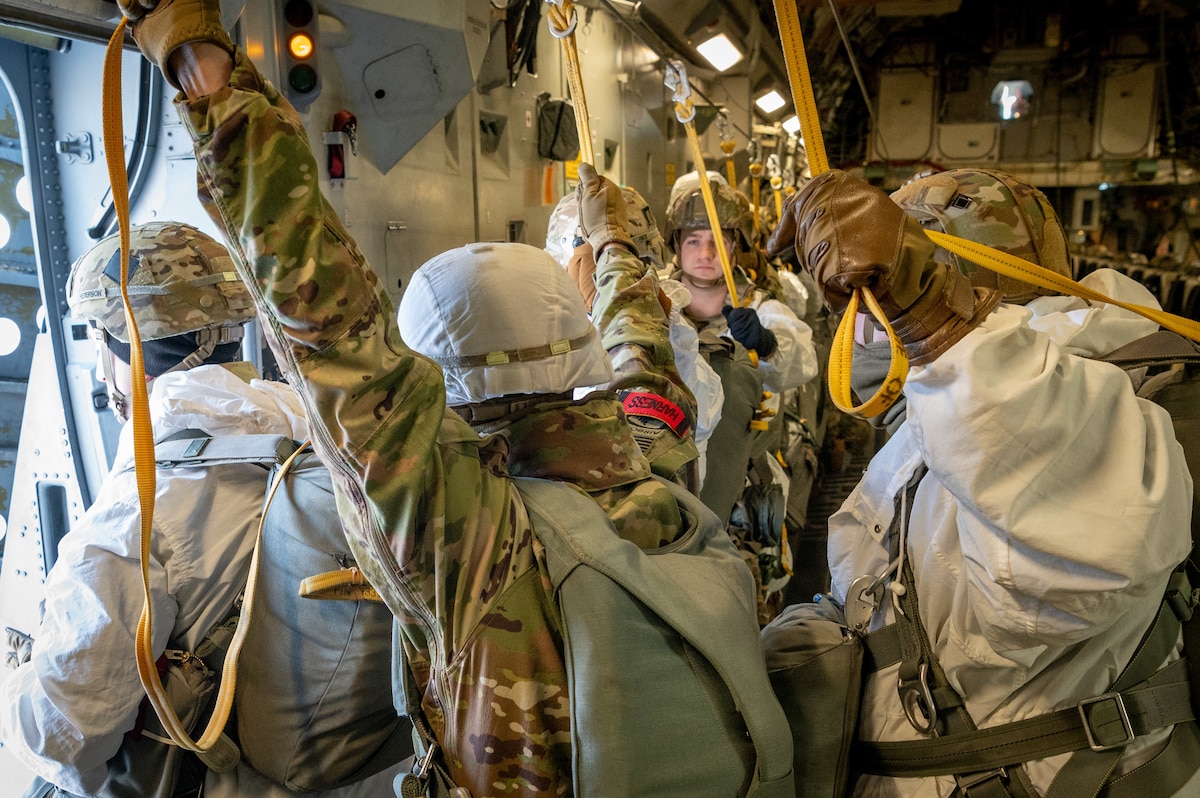 U.S. Army Paratroopers of the 2nd Brigade Combat Team, 11th Airborne Division prepare to jump from a C-17 Globemaster III at Joint Base Elmendorf-Richardson, Alaska, Jan. 30, 2024.