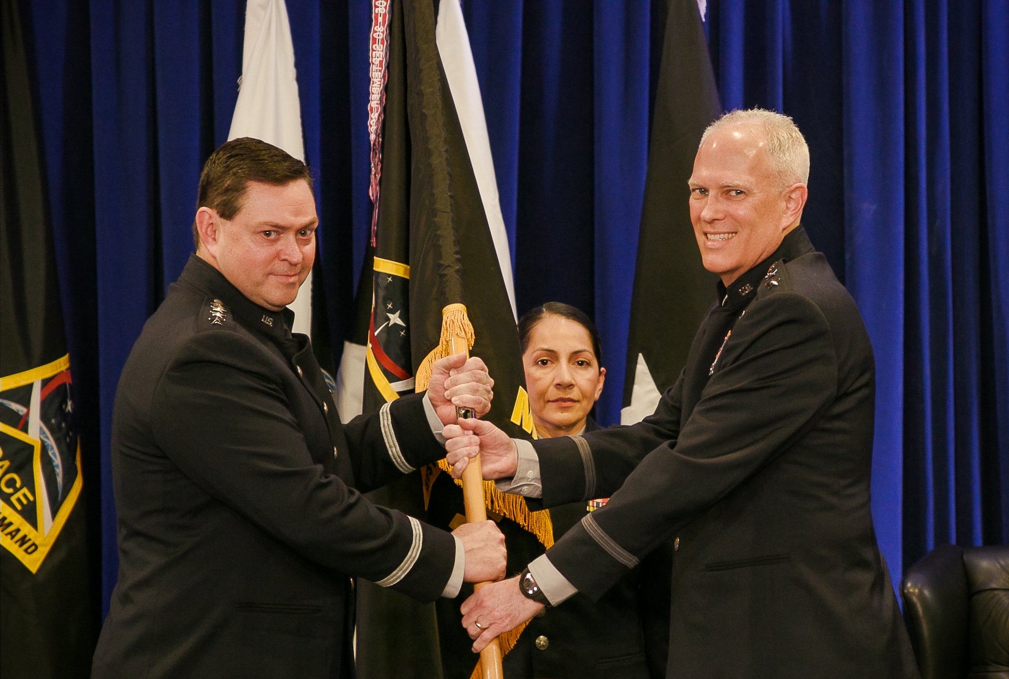 U.S. Space Force Lt. Gen. Philip Garrant, right, accepts the Space Systems Command (SSC) flag from Chief of Space Operations Gen. Chance Saltzman, left, during a change of command ceremony Feb. 1, 2024, at SSC headquarters on Los Angeles Air Force Base in El Segundo, Calif. With this change of command, Garrant became the second commander of SSC and is responsible for leading a global workforce of more than 15,000 military, civilian, and contractor personnel, as well as overseeing an annual $15.6 billion space acquisition budget, which ensures premier space capabilities are delivered timely to counter the threats in today's and tomorrow's contested space domain.