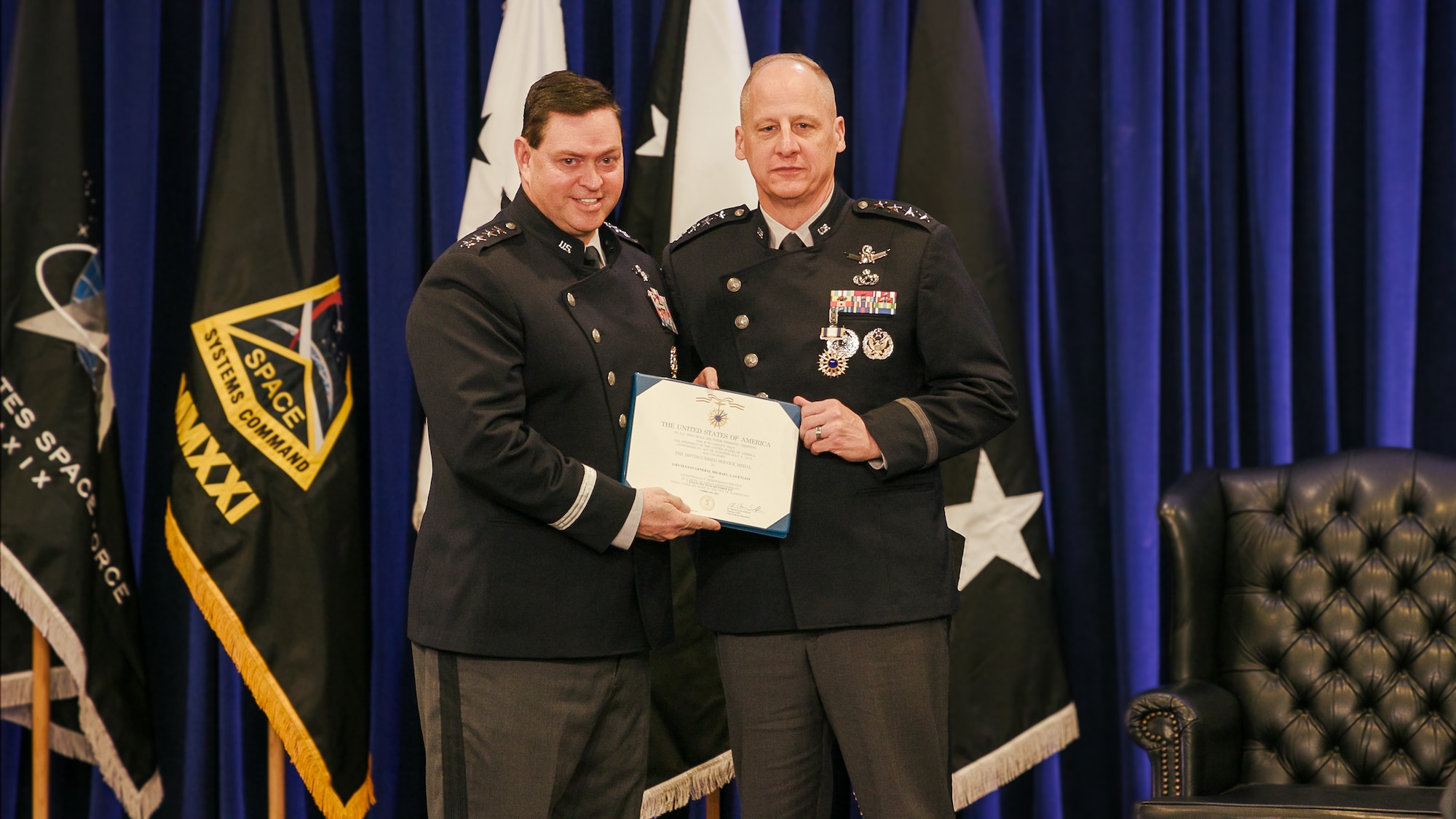 U.S. Space Force Gen. Chance Saltzman, Chief of Space Operations, presents a U.S. Air and Space Forces Distinguished Service Medal to U.S. Space Force Gen. Michael Guetlein, Space Systems Command’s (SSC) first commander and the USSF’s newest Vice Chief of Space of Operations, for his distinctive accomplishments and leadership during the SSC change of command ceremony Feb. 1, 2024, at SSC headquarters on Los Angeles Air Force Base in El Segundo, Calif. “For the last few years, this command has continued to fast-track space innovation under the leadership of its first and only commander, Gen. Mike Guetlein,” said Saltzman. “This team’s many historic achievements since its stand-up are a testament to the talent and the determinization of our Guardians…and equally as important, are a testament to the leadership of your commander.”