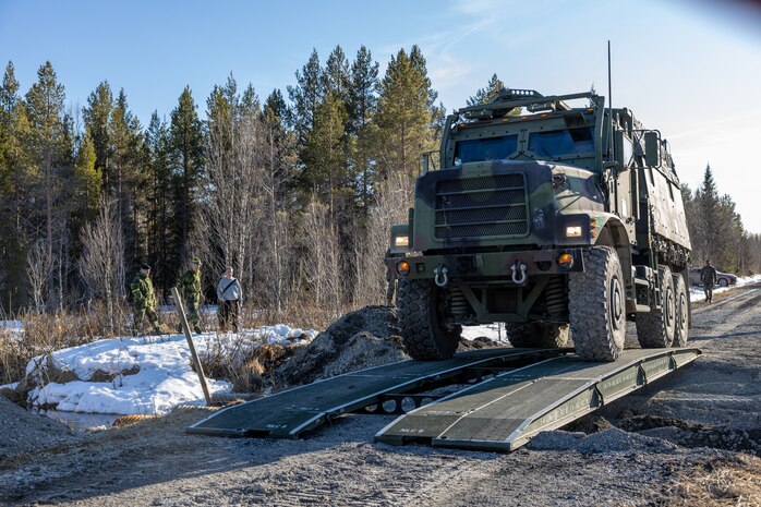 U.S. Marines with 2d Combat Engineer Battalion, 2d Marine Division, cross a gap with a viper bridge during viper bridge training near Ostersund, Sweden, April 17, 2023. Marines are deployed to Norway as part of Marine Rotational Forces Europe 23.1 which focuses on regional engagements throughout Europe by conducting various exercises, arctic cold-weather and mountain warfare training, and military-to-military engagements, which enhance overall interoperability of the U.S. Marine Corps with allies and partners. (U.S. Marine Corps photo by Sgt. Christian M. Garcia)