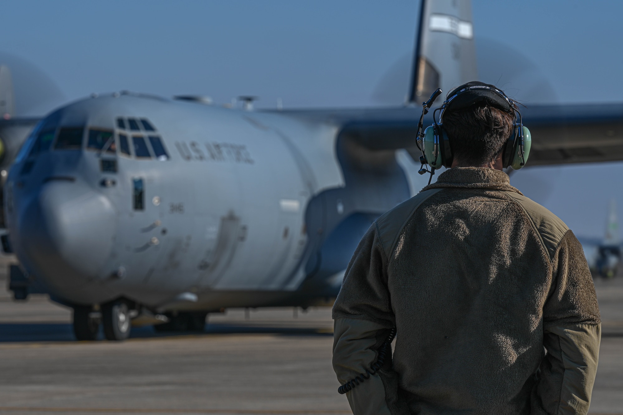 An Airman marshals a plane.