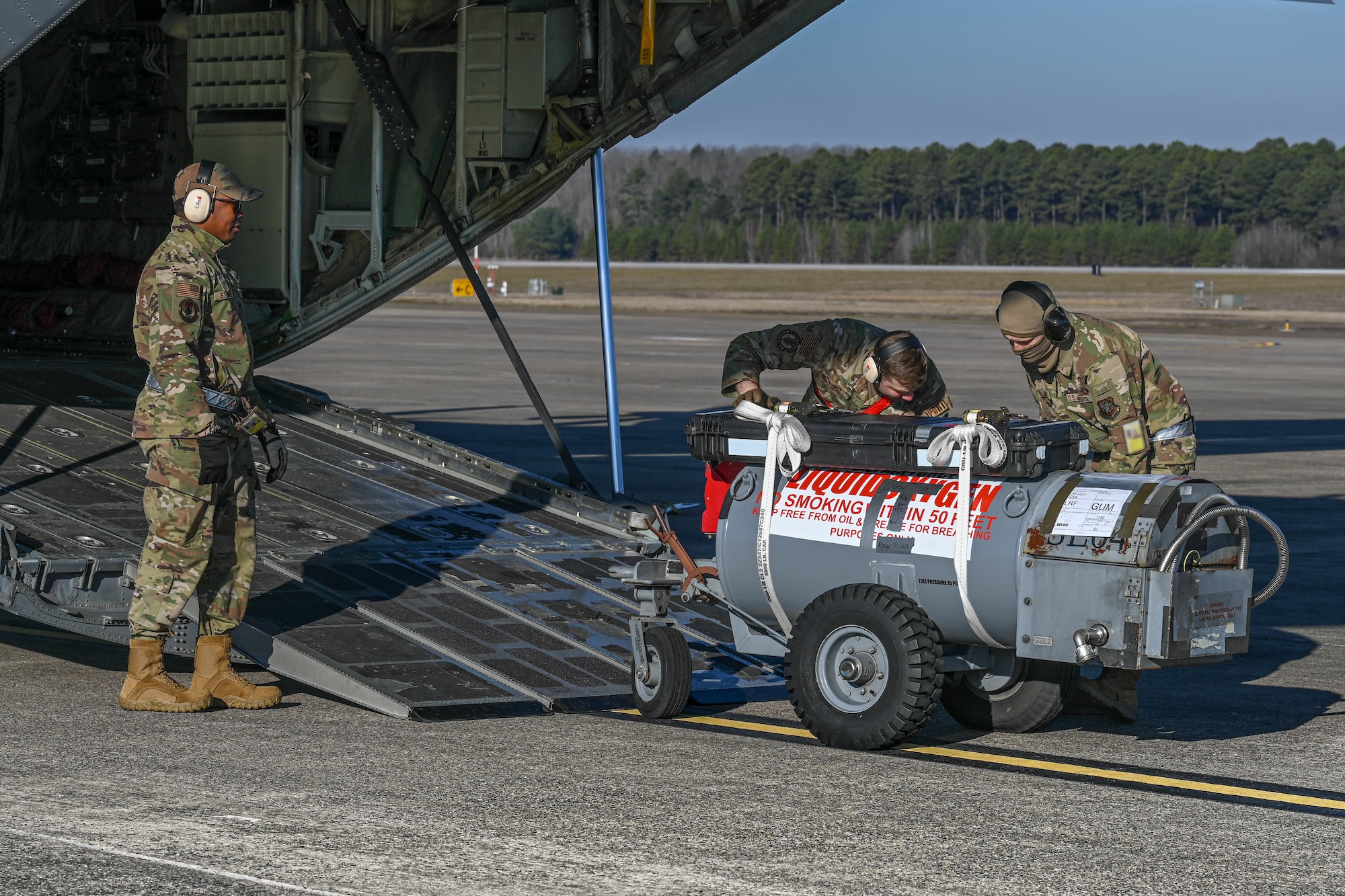 Airmen load cargo.