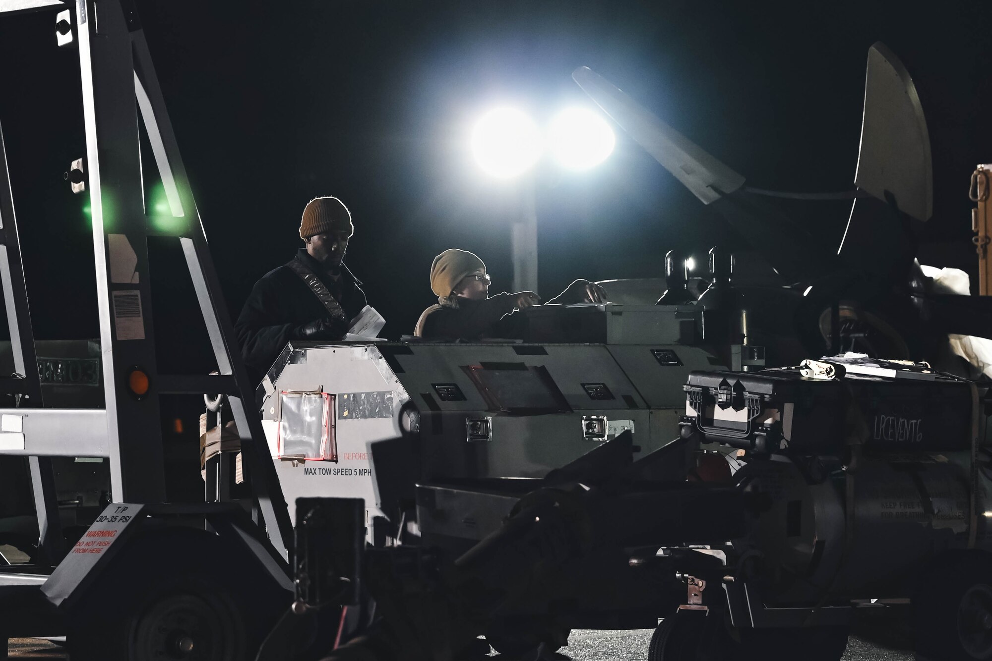 Airmen prepare cargo.