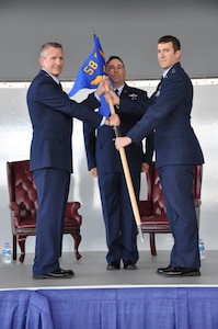 a man hands another man a flag