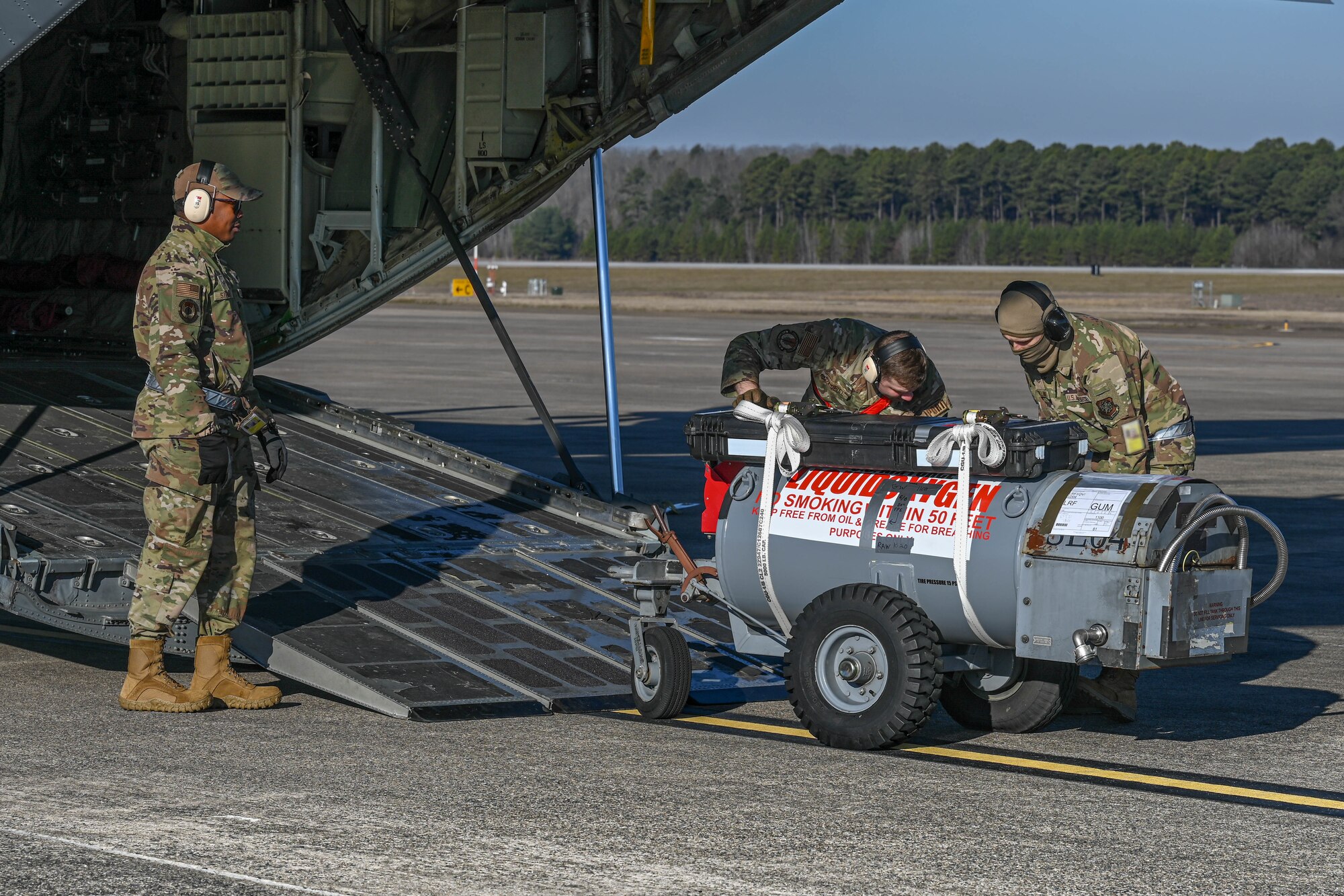 Airmen load cargo.