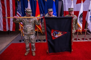 U.S. Space Force Chief Master Sgt. Grange S. Coffin, U.S. Space Forces-Space (S4S) senior enlisted leader, U.S. Space Force Chief of Space Operations Gen. Chance Saltzman, and Lt. Gen. Douglas A. Schiess, S4S commander and the Combined Joint Force Space Component Commander, ceremonially unfurl the S4S flag during a ceremony at Vandenberg Space Force Base, Calif., Jan. 31, 2024. Previously, Space Operations Command was assigned to U.S. Space Command as the Space Force service component, but this realignment of service component responsibilities under S4S optimizes force presentation for mission readiness. (U.S. Space Force photo by Tech. Sgt. Luke)