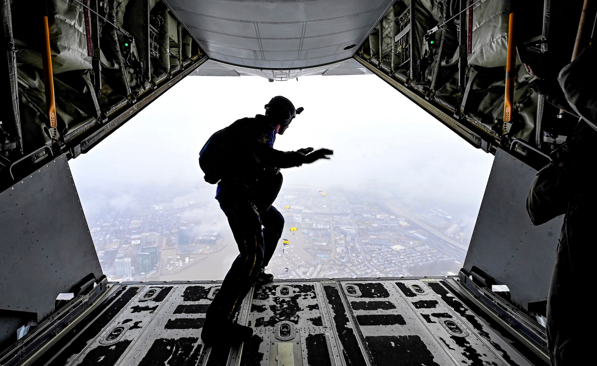 Man prepares to jump out of a plane.