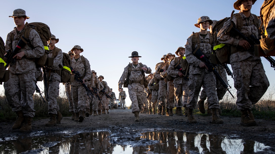 U.S. Marine Corps recruits with Delta Company, 1st Recruit Training Battalion, conduct an 8-kilometer hike at Marine Corps Base Camp Pendleton, California, Jan. 30, 2024. The purpose of the hike is to condition the recruits to rigorous terrain on Camp Pendleton in preparation for their 13-kilometer hike and culminating event -- the Crucible. (U.S. Marine Corps photo by Sgt. Yvonna Guyette)