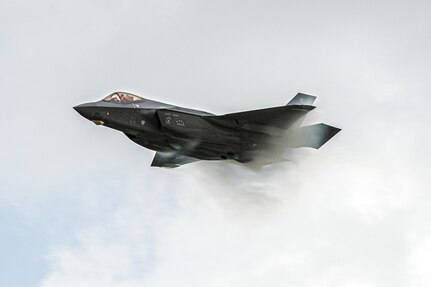 fighter jet flying right to left