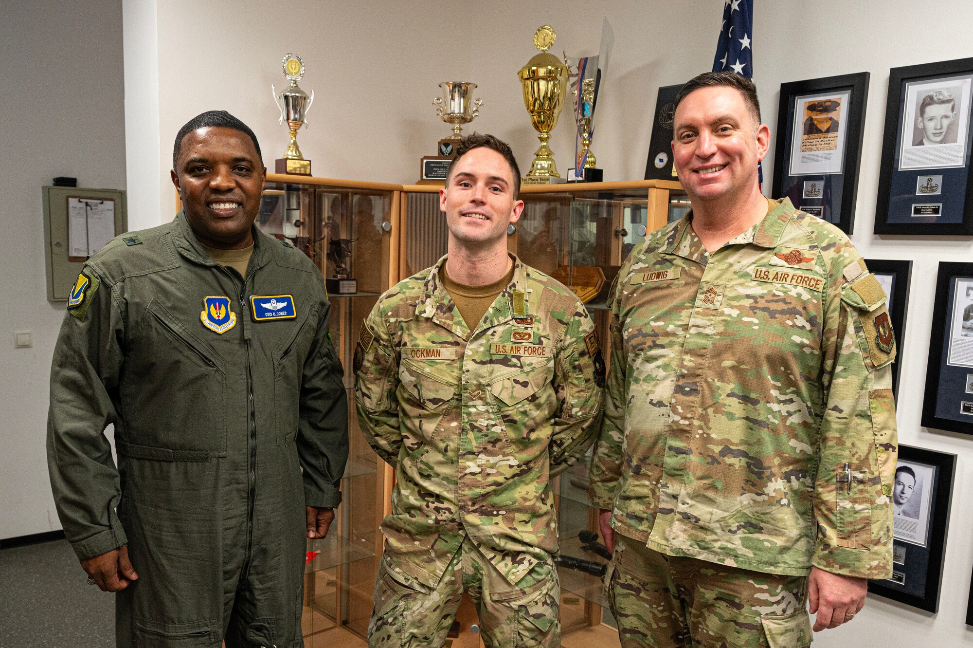 U.S. Air Force Airman 1st Class Kelsey Ockman, center, 786th Civil Engineer Squadron Explosive Ordnance Disposal apprentice, poses for a photo with Brig. Gen. Otis C. Jones, 86th Airlift Wing commander and Chief Master Sgt. Louis J. Ludwig, 86th AW command chief, at Ramstein Air Base, Germany, Jan. 30, 2024. Ockman earned the title of Airlifter of the Week because of his achievements including servicing Unit Type Code kits worth approximately $6.3 million and earning the 786th CES 3rd Quarter Hard Charger award. (U.S. Air Force photo by Senior Airman Thomas Karol)