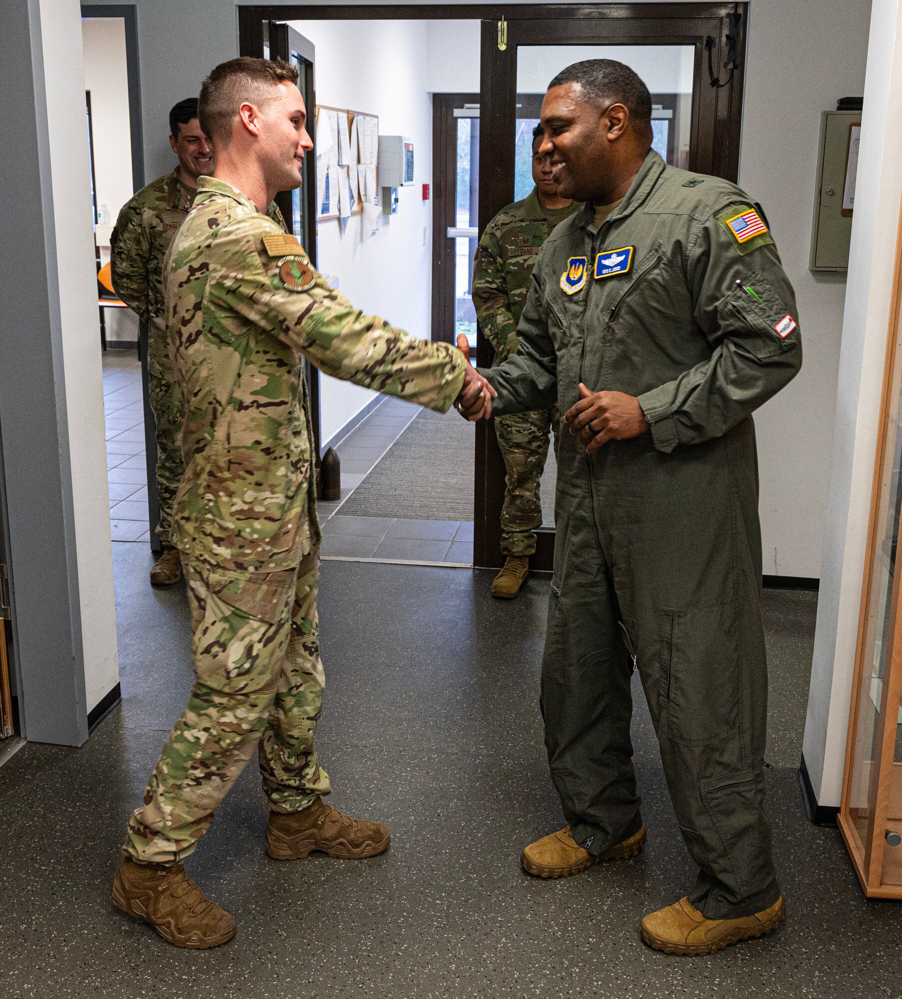 U.S. Air Force Airman 1st Class Kelsey Ockman, 786th Civil Engineer Squadron Explosive Ordnance Disposal apprentice, receives a coin from 86th Brig. Gen. Otis C. Jones Airlift Wing commander, at Ramstein Air Base, Germany, Jan. 30, 2024. Ockman earned the title of Airlifter of the Week for his hard work and dedication to the 86th AW mission and his EOD teammates. (U.S. Air Force photo by Senior Airman Thomas Karol)