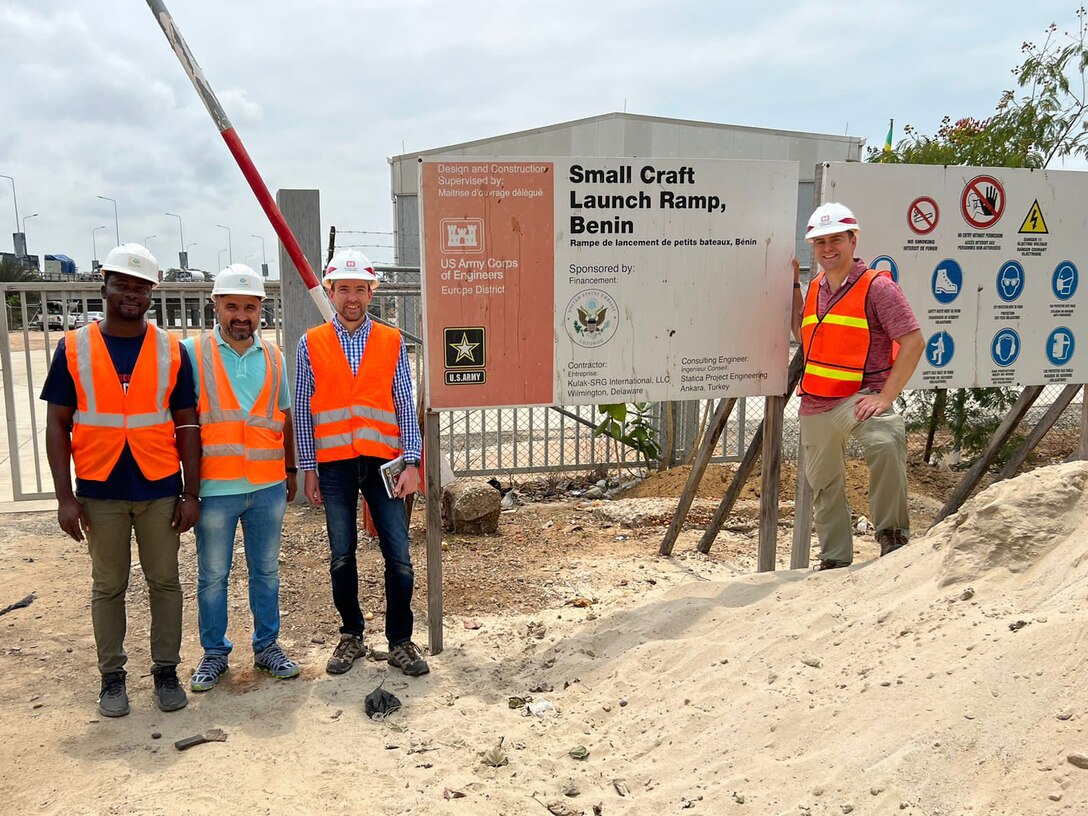 The local Beninese construction site lead and the contractor site supervisor pose with U.S. Army Corps of Engineers, Europe District Project Engineer Chris De Pooter and Europe District Project Engineer Capt. Ben Ketchum after an inspection of the recently completed boat launch project in Cotonou, Benin September 29, 2022. The U.S. Army Corps of Engineers delivered the project as part of a larger program led by the U.S. Africa Command and the U.S. Embassy in Benin in support of bolstering Beninese maritime policing capabilities as they play a key role in combatting regional piracy in the Gulf of Guinea. (Courtesy photo)