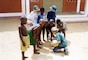 A young Ben Ketchum plays with Beninese children in 2002 while his family was in the country with a hospital ship his father captained that was associated with the non-profit Mercy Ships organization. The ship and its crew provided surgical care to impoverished communities in developing countries all over the world. Growing up around that instilled a desire to serve others in Ketchum and he ultimately joined the U.S. Army as an engineer where he is now a captain with the U.S. Army Corps of Engineers and supporting humanitarian assistance and other projects in Benin and several other countries in Africa and Europe. (Courtesy photo)