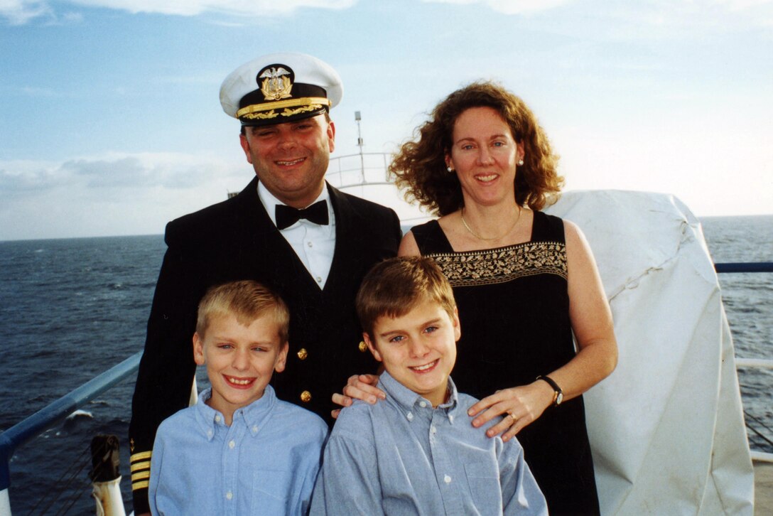 A young Ben Ketchum, lower right, is pictured here with his family aboard the hospital ship his father, Clem Ketchum, top left, captained that was associated with the non-profit Mercy Ships organization. Clem, now a retired U.S. Army lieutenant colonel; Ketchum’s mother Jennifer, a retired U.S. Coast Guard captain; and Ketchum’s brother Will, now a U.S. Army captain serving as a general surgeon, spent years traveling and providing medical care to impoverished communities around the world. Ben, now Capt. Ben Ketchum chose to continue his family’s legacy of serving others as an engineer officer in the U.S. Army and now supports humanitarian assistance and other projects in several countries in Africa and Europe as part of the U.S. Army Corps of Engineers, Europe District. (Courtesy photo)