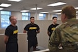 Pvt. Jared Haggard (left), chemical, biological, radiological, and nuclear specialist, 208th Transportation Company, 653rd Regional Support Group, explains his background to Staff Sgt. Mark Morton (right), human resources noncommissioned officer, 653rd RSG, after completing a height and weight with fellow competitors prior to a brigade Best Warrior Competition, Jan. 30, Armed Forces Reserve Center, Mesa, Ariz. (U.S. Army Reserve Photo by Maj. Alun Thomas, 653rd Regional Support Group Public Affairs)