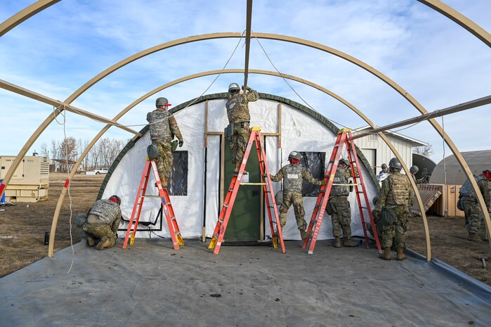 Airmen installing a tent