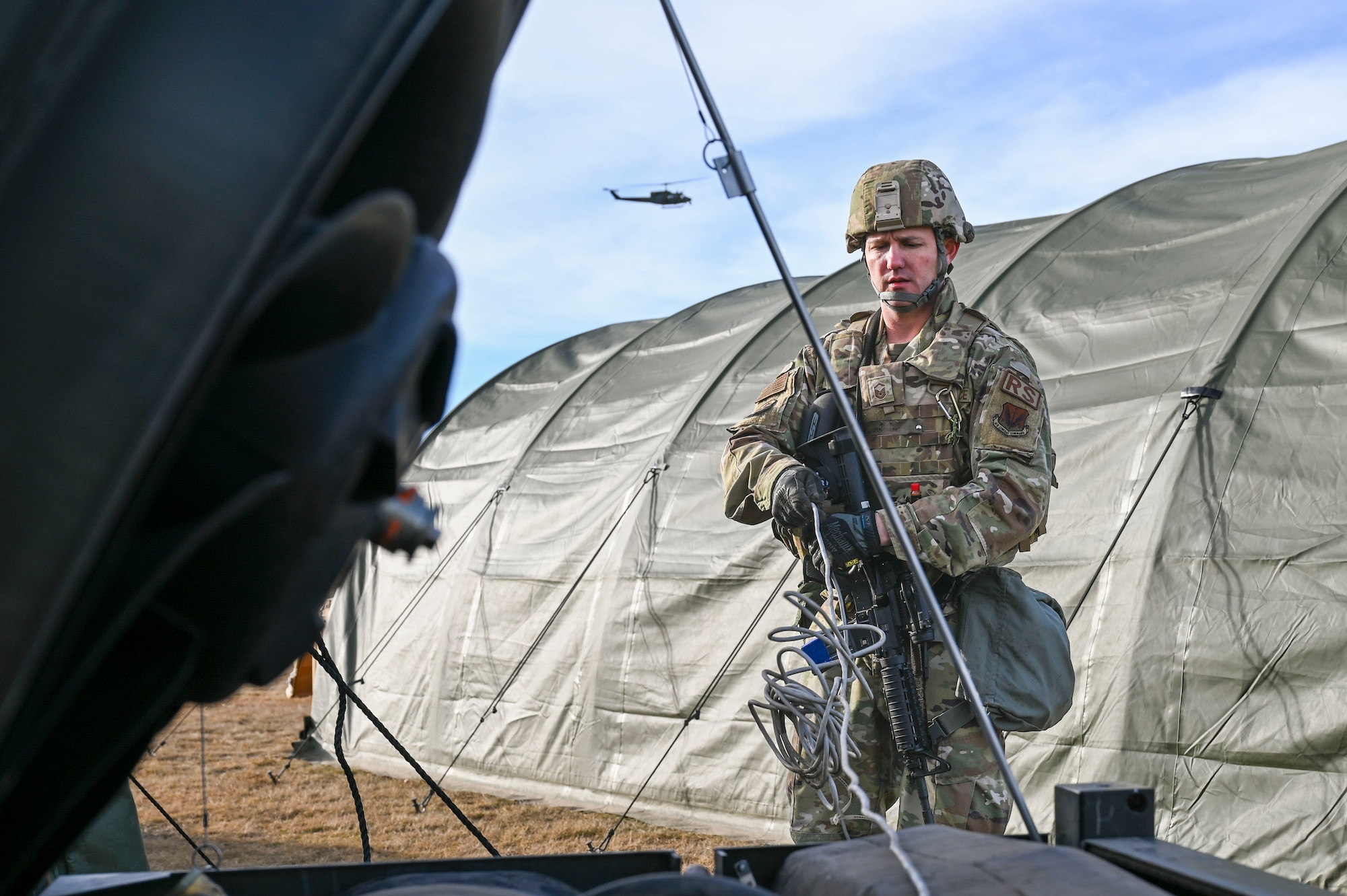 An Airman untangling a wire