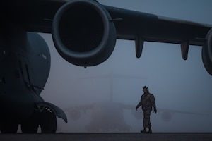 Senior Airman Hector Orenga, 305th Air Mobility Wing crew chief, conducts engine inspections