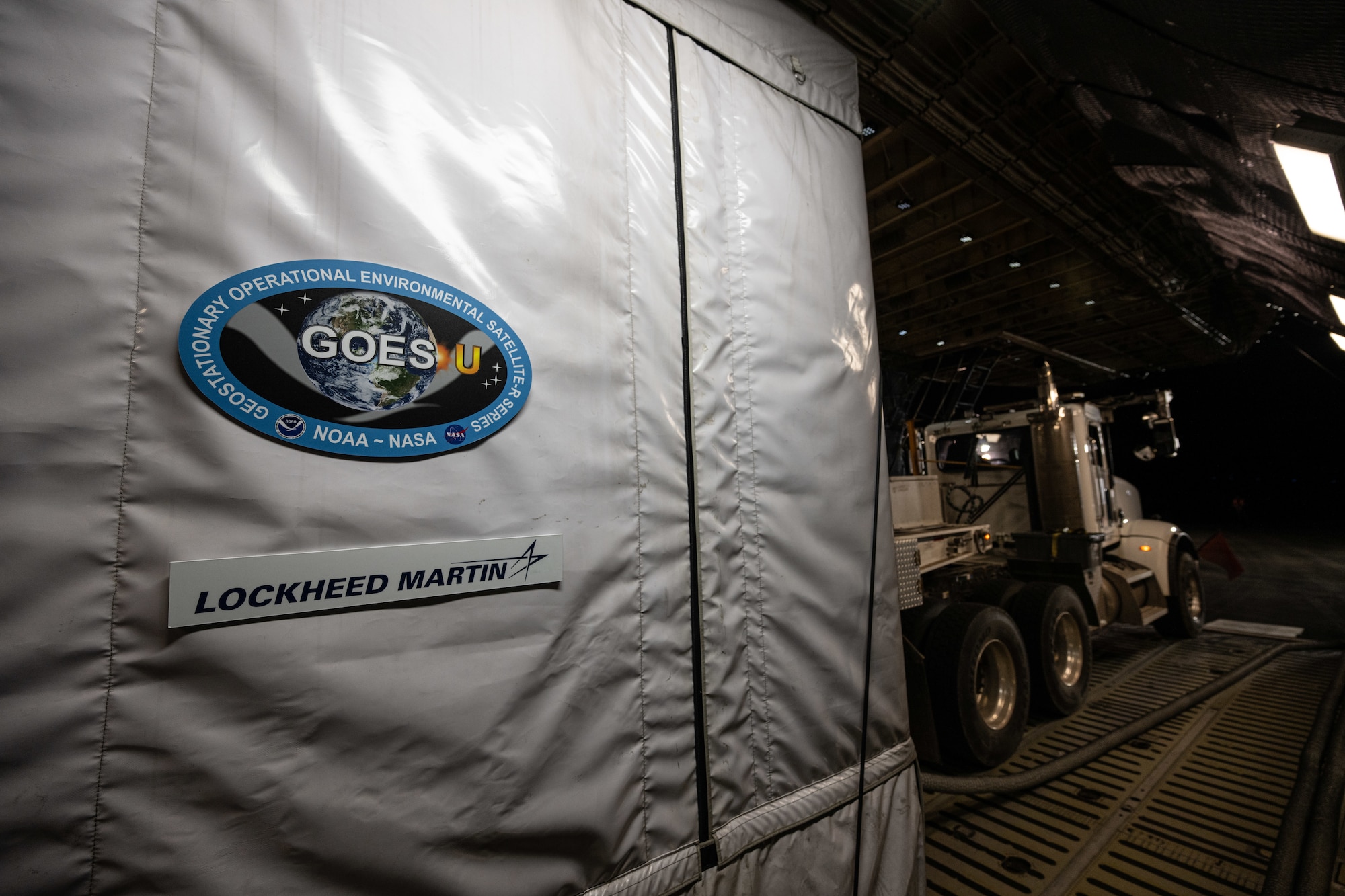 A National Oceanic and Atmospheric Administration Geostationary Operational Environmental Satellite sits on a U.S. Air Force C-5M Super Galaxy at NASA Kennedy Space Center on Merritt Island, Florida, Jan. 23, 2024. GOES-U, the final spacecraft in the GOES-R series of weather and climate satellites, was transported by 9th AS Airmen to NASA’s Kennedy Space Center ahead of its scheduled launch in April 2024. GOES-U will be able to monitor severe weather, identify volcanic eruptions, measure land and sea surface temperatures, provide early alerts to emergency responders during wildfires and observe solar flares that could impact telecommunication on and around Earth. (U.S. Air Force photo by Staff Sgt. Marco A. Gomez)