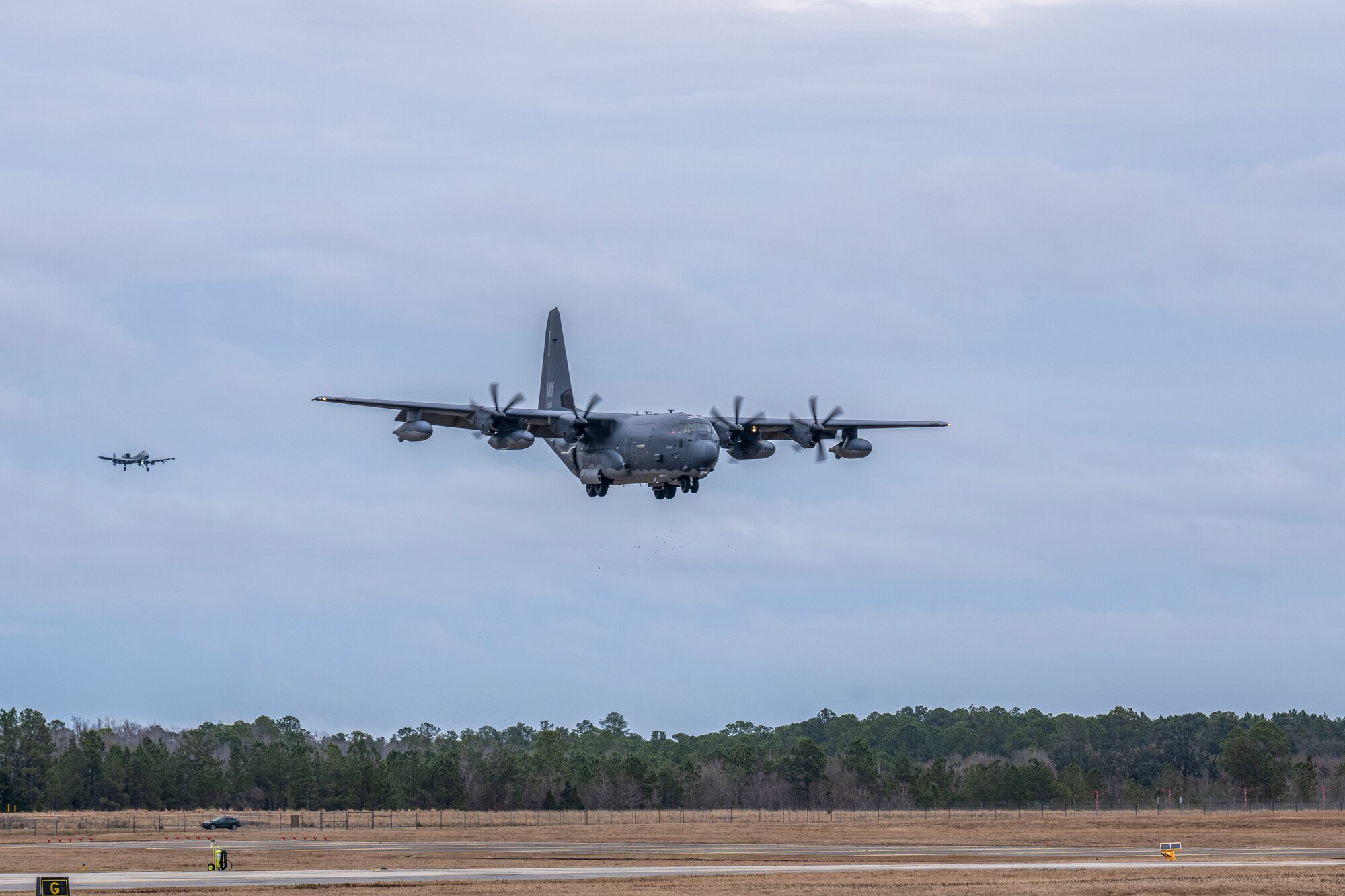 An HC-130J Combat King II and an A-10C Thunderbolt II assigned to the 23rd Wing, prepare to land