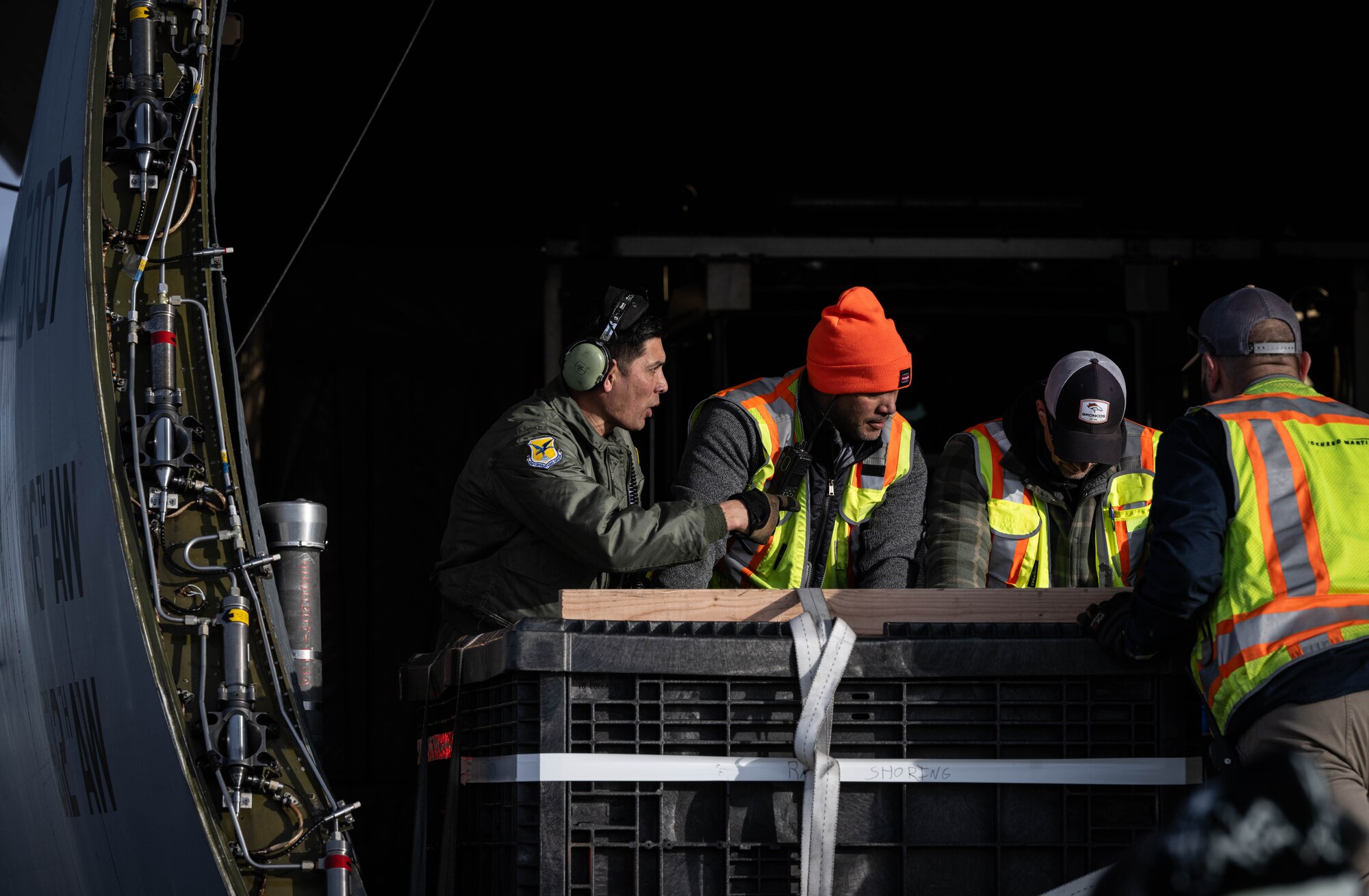 U.S. Air Force Master Sgt. Joshua Cutrer, 9th Airlift Squadron loadmaster, coordinates with Lockheed Martin crew members while loading a National Oceanic and Atmospheric Administration Geostationary Operational Environmental Satellite onto a C-5M Super Galaxy at Buckley Space Force Base, Colorado, Jan. 22, 2024. GOES-U, the final spacecraft in the GOES-R series of weather and climate satellites, will be transported by 9th AS aircrew to NASA’s Kennedy Space Center ahead of its scheduled launch in April 2024. (U.S. Air Force photo by Staff Sgt. Marco A. Gomez)