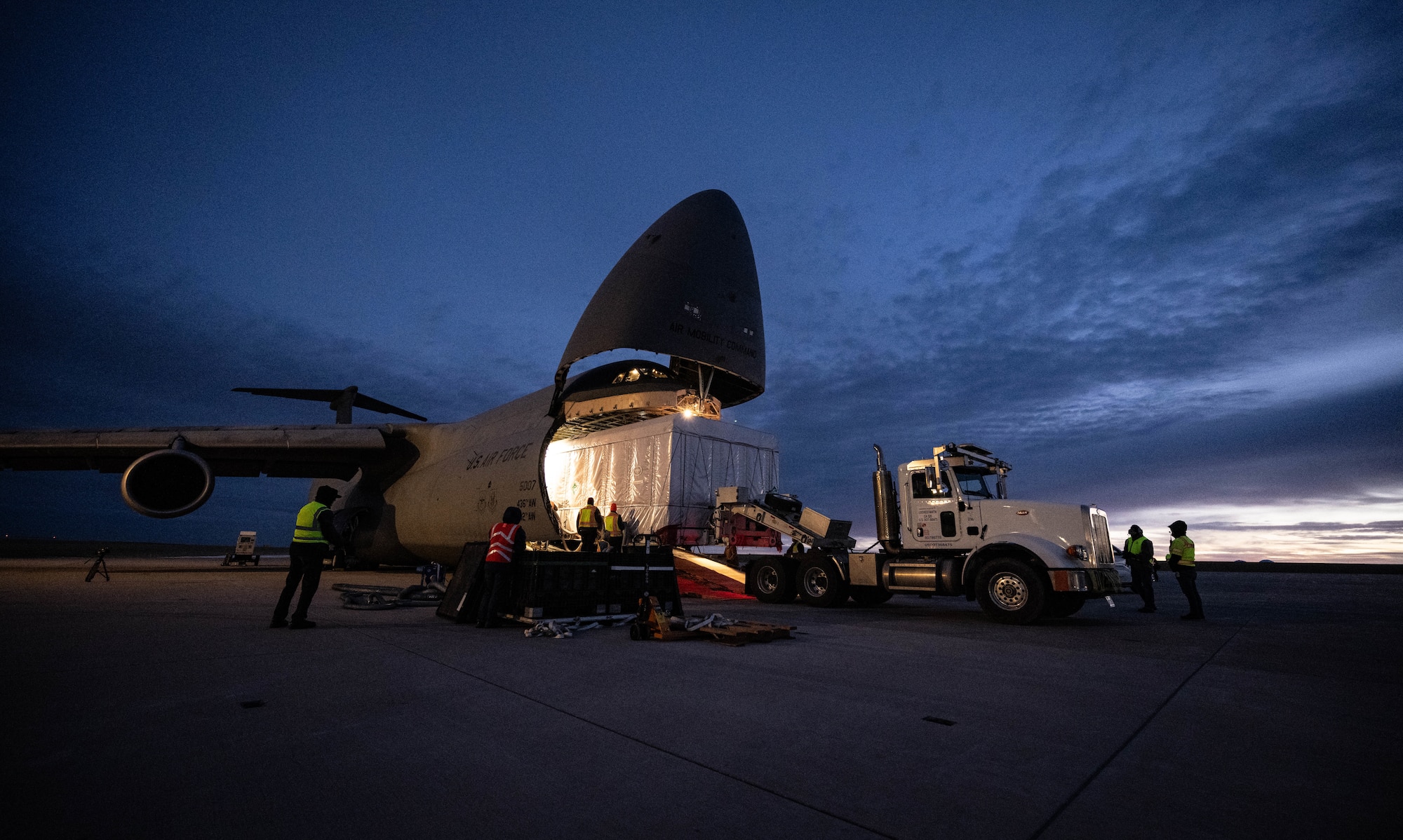 U.S. Airmen assigned to the 9th Airlift Squadron and Lockheed Martin crew members load a National Oceanic and Atmospheric Administration Geostationary Operational Environmental Satellite onto a C-5M Super Galaxy at Buckley Space Force Base, Colorado, Jan. 22, 2024. GOES-U will be able to monitor severe weather, identify volcanic eruptions, measure land and sea surface temperatures, provide early alerts to emergency responders during wildfires and observe solar flares that could impact telecommunication on and around Earth. (U.S. Air Force photo by Staff Sgt. Marco A. Gomez)