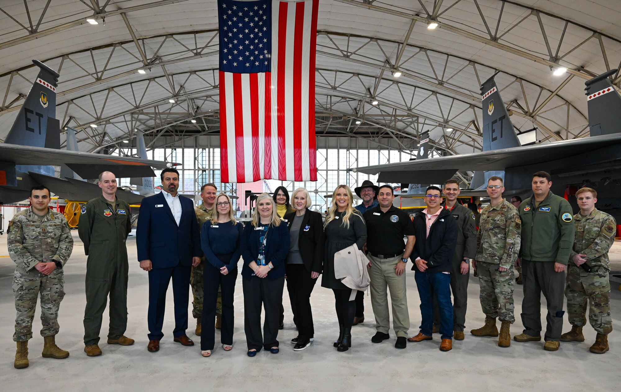 350th Spectrum Warfare Wing Honorary Commanders and wing members pose for a group photo at the end of a wing immersion tour at Eglin Air Force Base, Fla., Jan. 25, 2024. The Honorary Commander program aims at building partnerships in the local community by pairing local leaders with Air Force commanders. (U.S. Air Force photo by Capt. Benjamin Aronson)