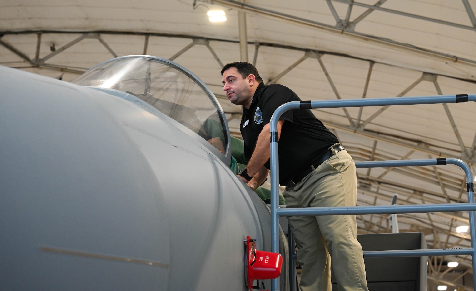 Matthew Pace, 850th Spectrum Warfare Group honorary commander, looks inside the cockpit of an F-15EX Eagle II during a tour at Eglin Air Force Base, Fla., Jan. 25, 2024. The 350th Spectrum Warfare Wing's Honorary Commanders had the opportunity to learn about the wing's missions and see aircraft up close. (U.S. Air Force photo by Capt. Benjamin Aronson)