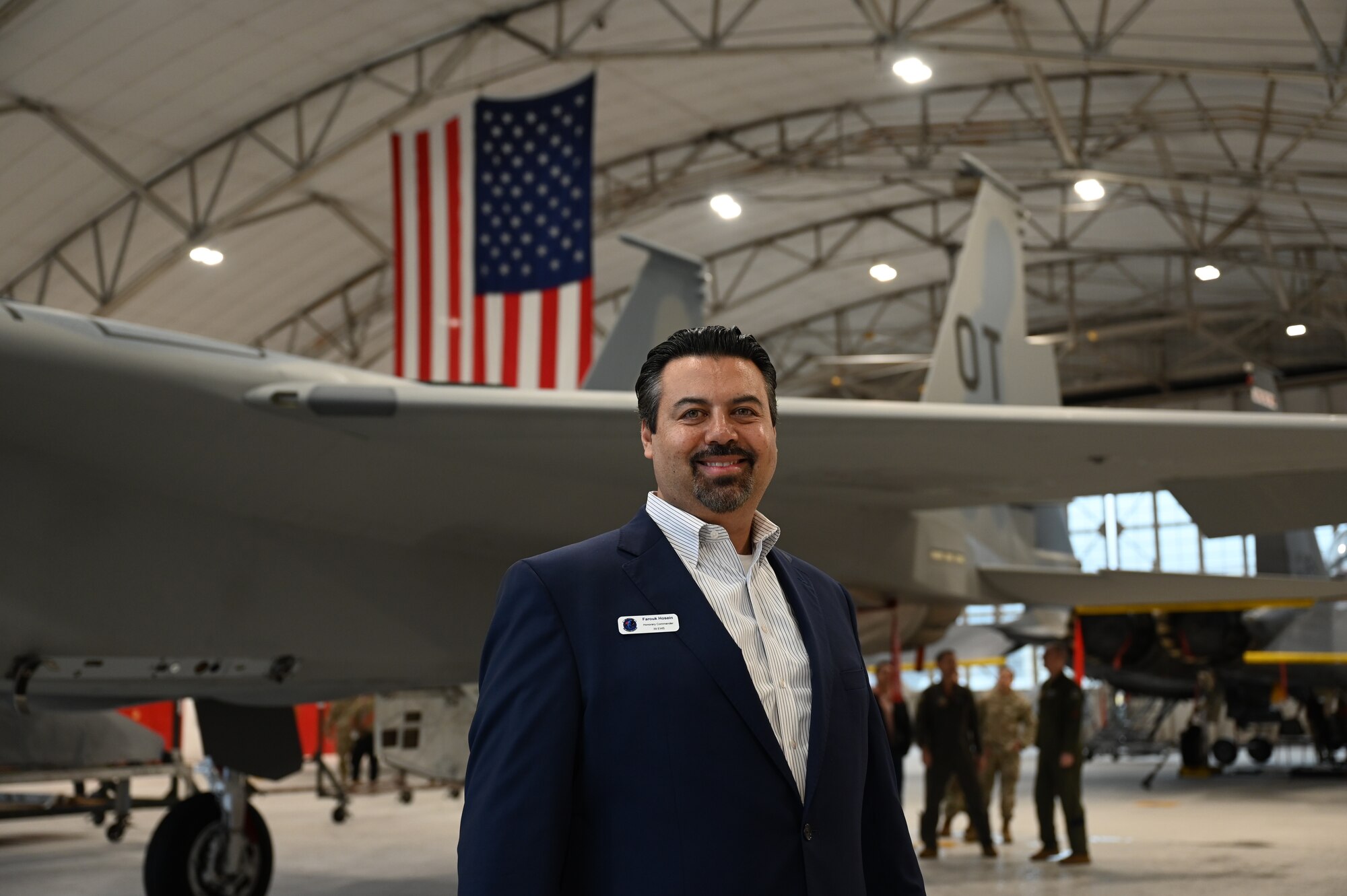 Farouk Hosein, 39th Electronic Warfare Squadron honorary commander, poses for a photo at the end of a wing immersion tour at Eglin Air Force Base, Fla., Jan. 25, 2024. The 350th Spectrum Warfare Wing welcomed its Honorary Commanders to learn about its mission sets and see aircraft stationed at Eglin. (U.S. Air Force photo by Capt. Benjamin Aronson)