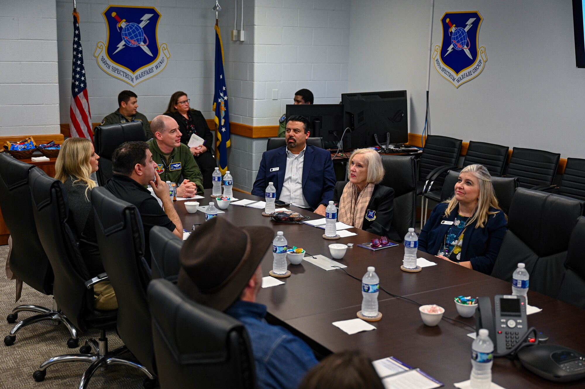 Honorary Commanders for the 350th Spectrum Warfare Wing attend an immersion tour briefing to learn more about the wing’s mission at Eglin Air Force Base, Fla., Jan. 25, 2024. The Honorary Commander program pairs community leaders with Air Force commanders to foster relationships and understanding between the Air Force and the local community. (U.S. Air Force photo by Capt. Benjamin Aronson)