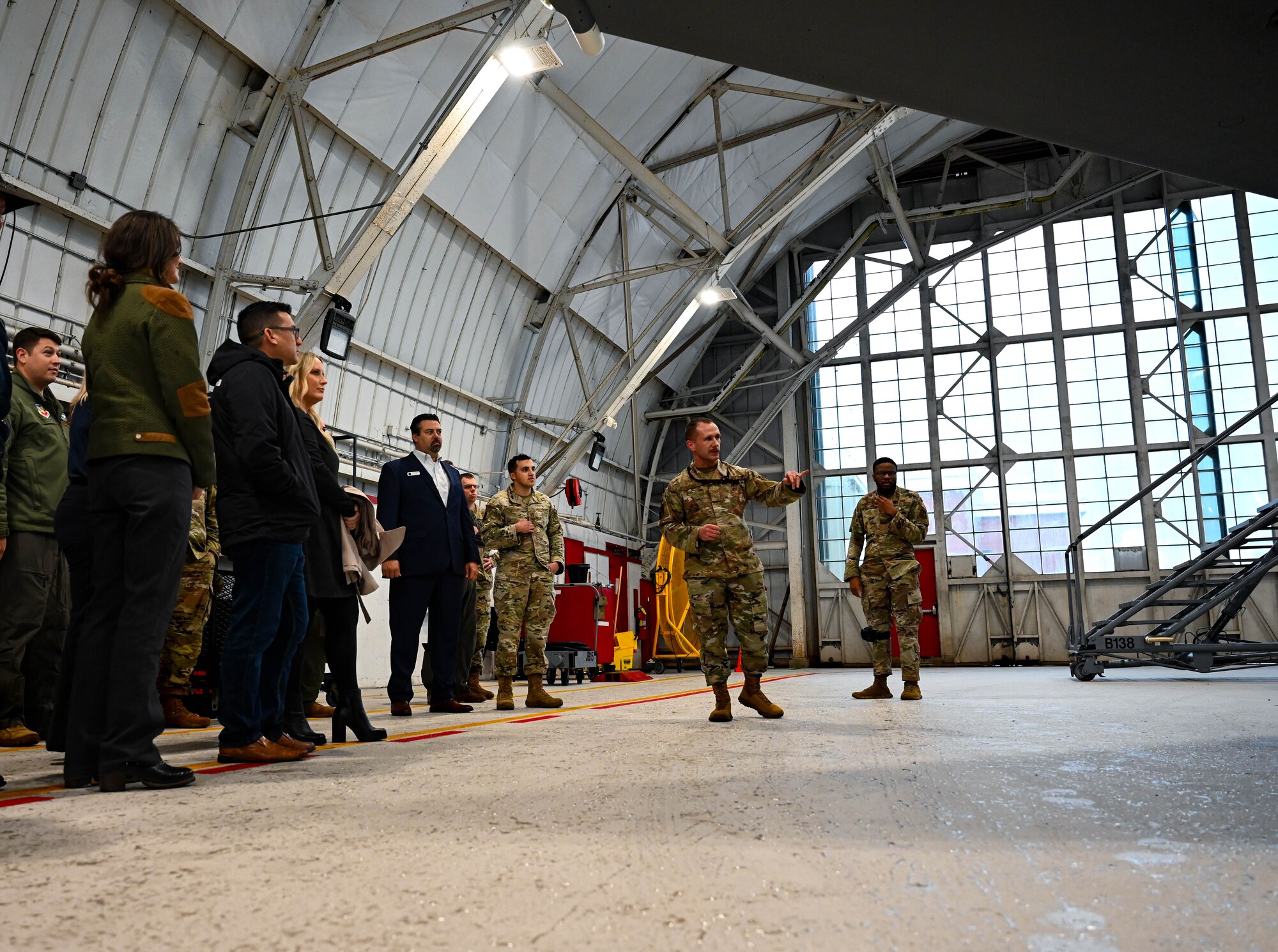 U.S. Air Force Tech. Sgt. Travis Young, 96th Aircraft Maintenance Squadron aircraft section NCOIC, briefs the 350th Spectrum Warfare Wing Honorary Commanders on the F-15E and F-15EX Eagle IIs during a tour at Eglin Air Force Base, Fla., Jan. 25, 2024. The mission of the 96th AMXS is to provide air power to Air Force Material Command and Air Combat Command to advance the combat capability of America's Air Force. (U.S. Air Force photo by Capt. Benjamin Aronson)