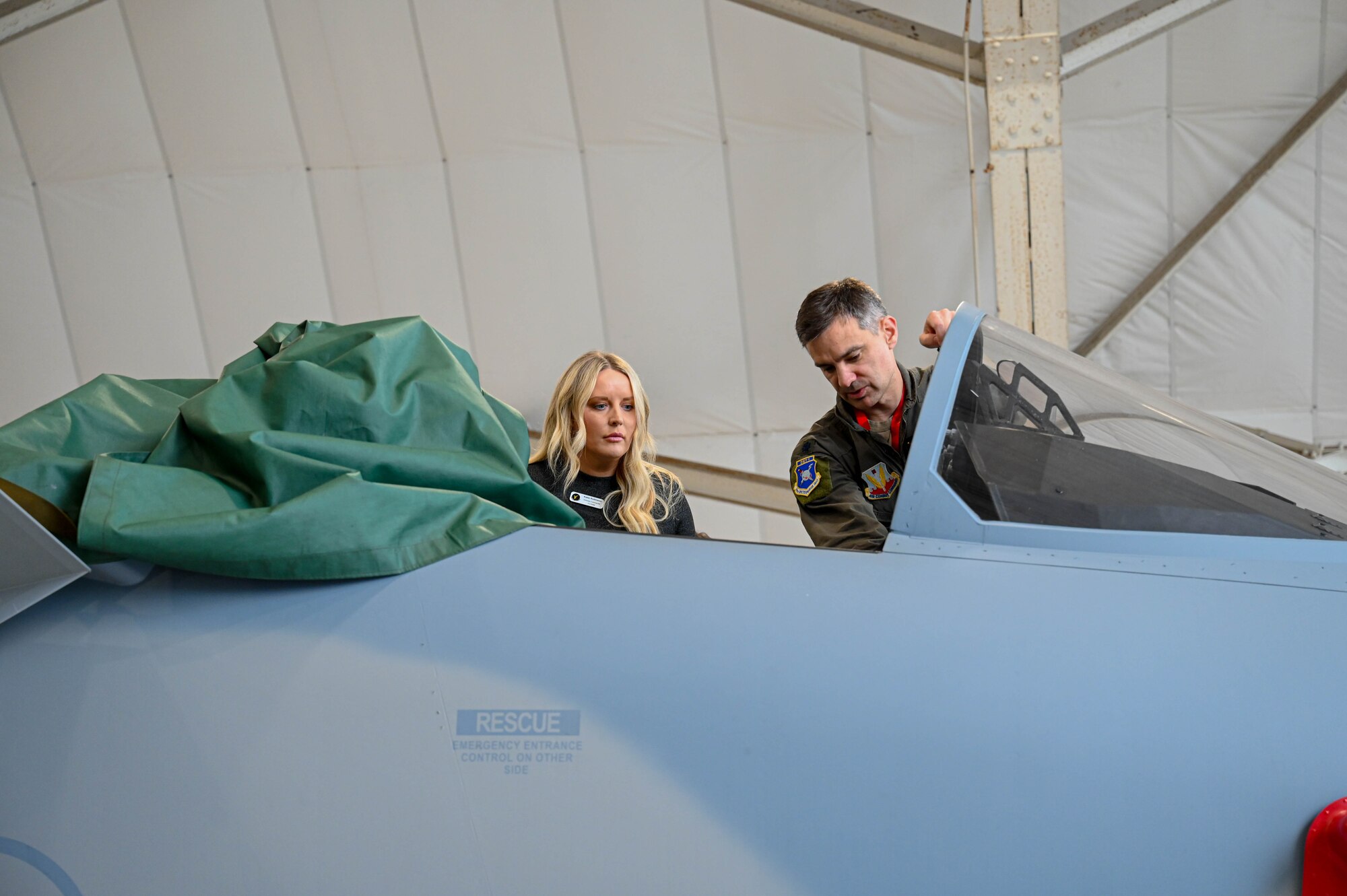 Katie Robison, 68th Electronic Warfare Squadron honorary commander, is briefed by U.S. Air Force Lt. Col. Luke Marron, 350th Spectrum Warfare Group, Detachment 1 commander, on the F-15EX Eagle II during an immersion tour at Eglin Air Force Base, Fla., Jan. 25, 2024. On the tour, Honorary Commanders were briefed on each of the units’ missions for the wing and shown statics of the F-15E and F-15EX. (U.S. Air Force photo by Capt. Benjamin Aronson)