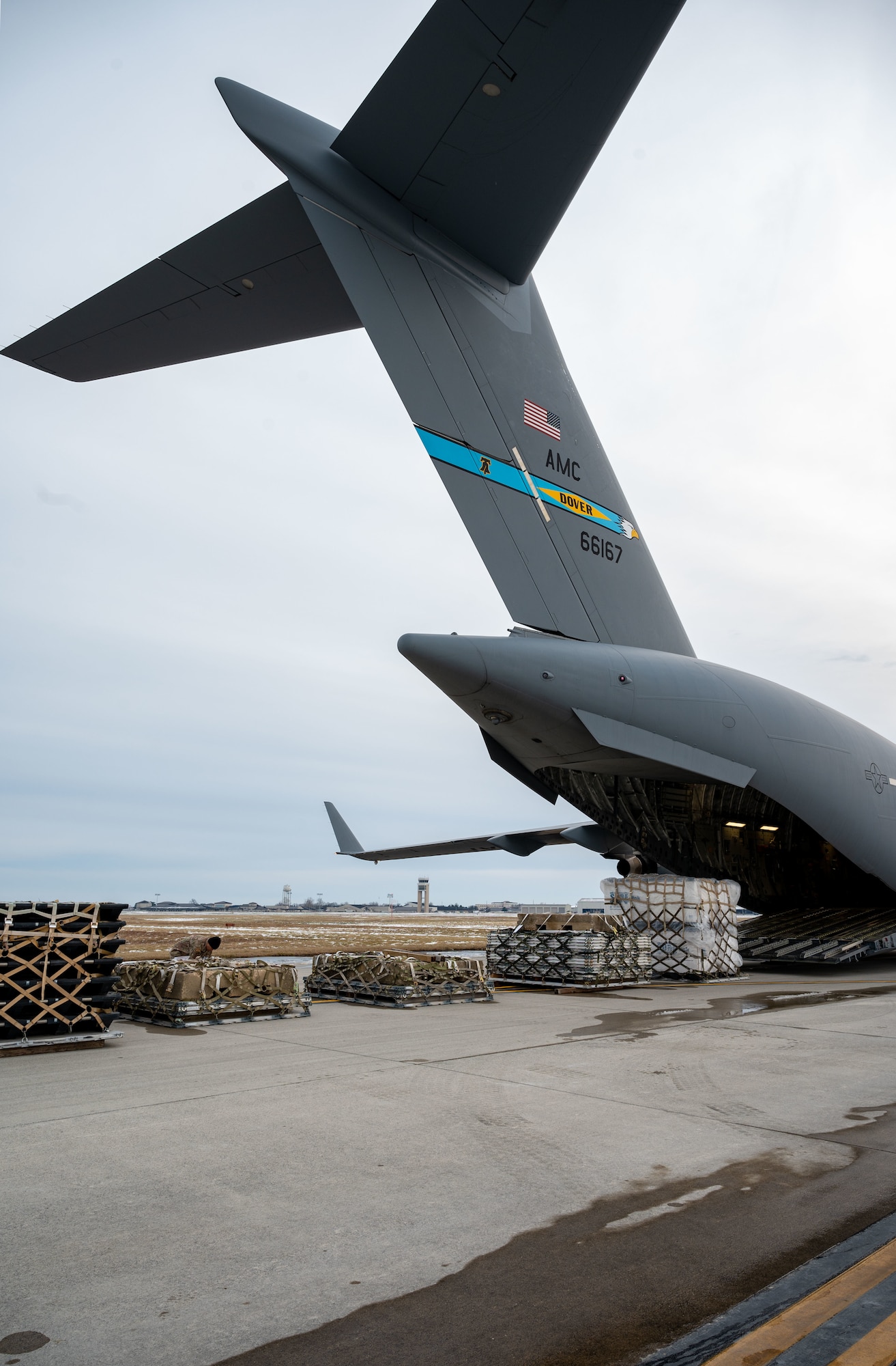 A C-17 Globemaster III drops cargo during combat offload Method C testing at Dover Air Force Base, Delaware, Jan. 23, 2024. The new combat offload Method C would allow C-17s to deliver cargo without the assistance of any material handling equipment. (U.S. Air Force photo by Airman 1st Class Amanda Jett)