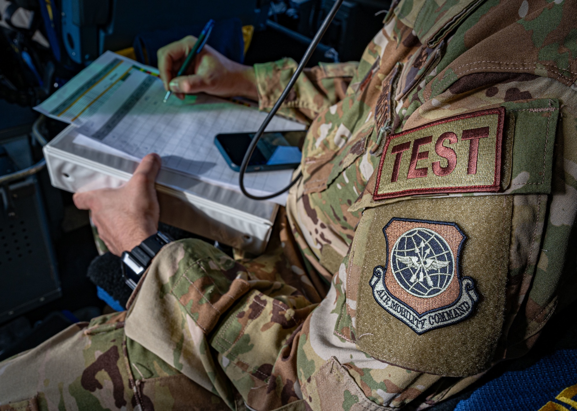 U.S. Air Force Capt. Daniel Fresella, Air Mobility test director, takes notes during combat offload Method C testing at Dover Air Force Base, Delaware, Jan. 23, 2024. The new combat offload Method C would allow C-17 Globemaster IIIs to deliver cargo without the assistance of any material handling equipment. (U.S. Air Force photo by Airman 1st Class Amanda Jett)