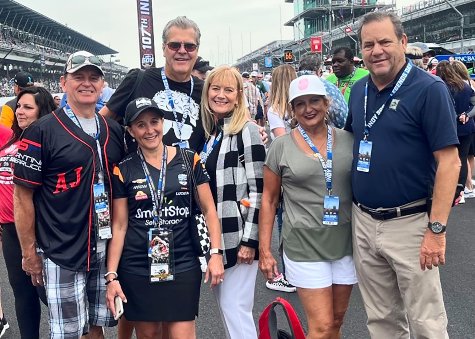 A group of people attending a race pose for a photo.