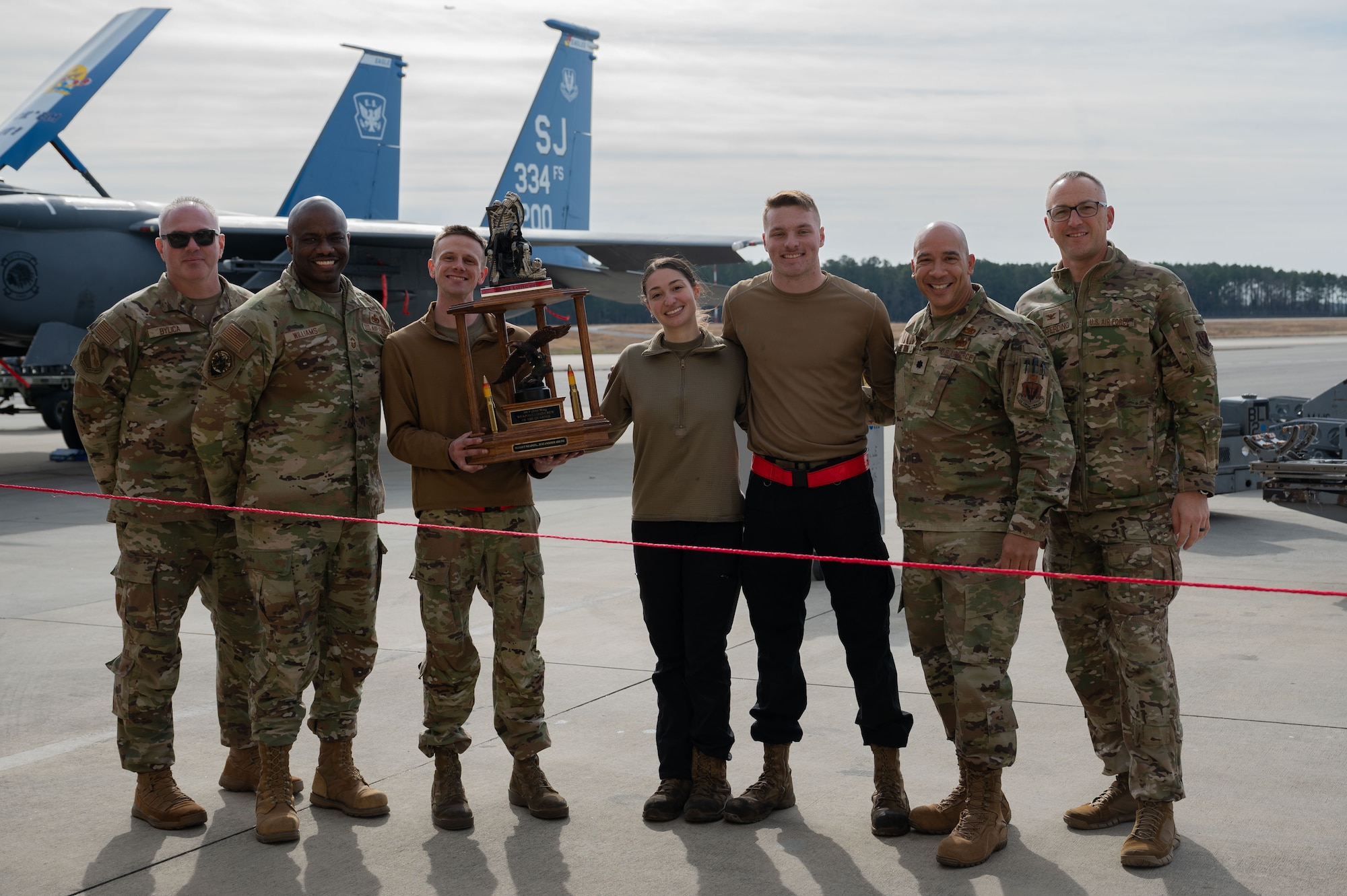 Airmen from the 333rd Fighter Generation Squadron receive a trophy after winning a quarterly load crew competition at Seymour Johnson Air Force Base, North Carolina, Jan. 12, 2024. Competition events include a 20-question knowledge test, weapons building and loading procedures and a composite toolkit inspection. (U.S. Air Force photo by Airman 1st Class Rebecca Sirimarco-Lang)