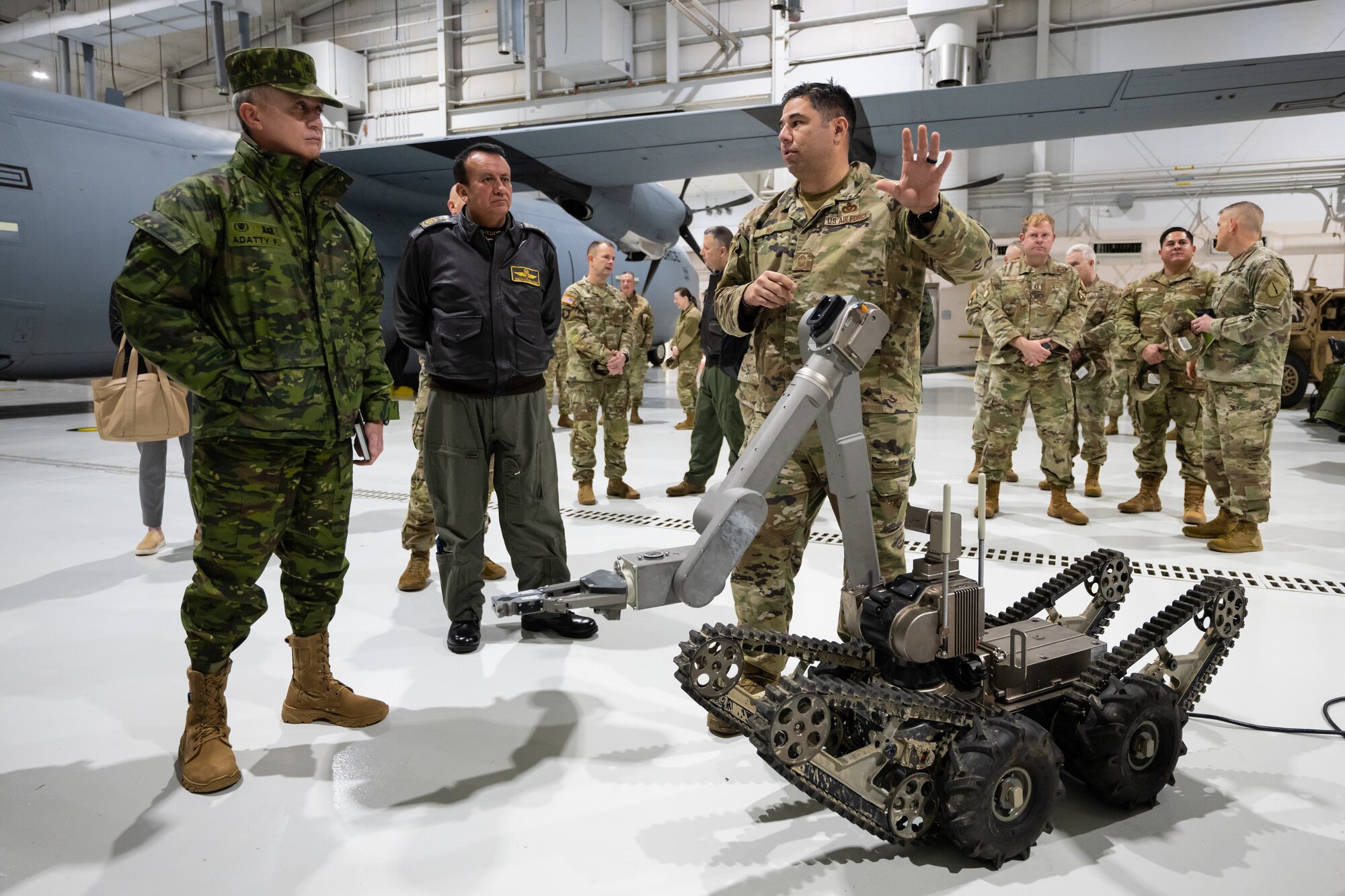 U.S. Air Force Chief Master Sgt. Matthew Wilt, right, superintendent of the Kentucky Air National Guard’s 123rd Explosive Ordnance Disposal Flight, demonstrates a remote-controlled EOD robot with Ecuadorian military leaders at the Kentucky Air National Guard Base in Louisville, Ky., Jan. 31, 2024. The Ecuadorians are visiting this week to exchange information with the Kentucky National Guard as part of the State Partnership Program, a National Guard Bureau effort that pairs Guard units with foreign allies to foster enhanced understanding across all aspects of civil and military affairs. (U.S. Air National Guard photo by Dale Greer)