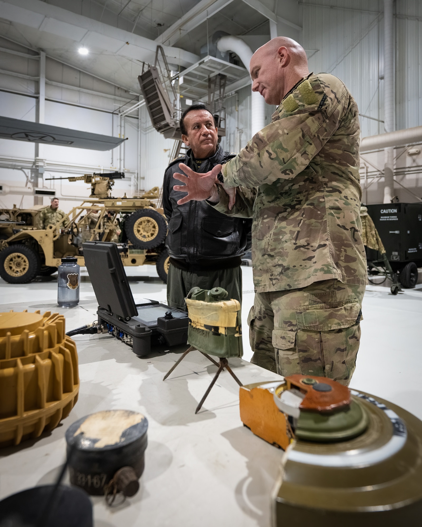 U.S. Air Force Master Sgt. Dustin Turner, right, an explosive ordnance disposal specialist assigned to the Kentucky Air National Guard’s 123rd Airlift Wing, discusses the use of remote-controlled EOD robots with Ecuadorian Air Force Maj. Gen. Mauricio Xavier Salazar at the Kentucky Air National Guard Base in Louisville, Ky., Jan. 31, 2024. Salazar is one of several Ecuadorian military leaders visiting this week to exchange information with the Kentucky National Guard as part of the State Partnership Program, a National Guard Bureau effort that pairs Guard units with foreign allies to foster enhanced understanding across all aspects of civil and military affairs. (U.S. Air National Guard photo by Dale Greer)