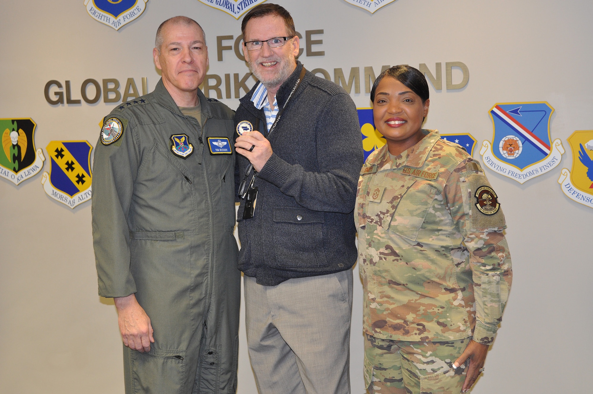 From left, Gen. Thomas Bussiere, commander of Air Force Global Strike Command; Andrew Robinson, logistics programmer in AFGSC’s A4 Directorate; and Chief Master Sgt. Melvina Smith, command chief of AFGSC, pose together for a photo at Barksdale Air Force Base, Louisiana, Dec. 18, 2023. Robinson was coined by Bussiere and recognized by AFGSC leadership for his years of outstanding performance in the command’s Weapon Systems Sustainment Branch managing helicopter maintenance, services and acquisition contracts for the command and the Air Force as well as being the Department of the Air Force’s Outstanding Air Force Services Program Manager of the Year in 2022. (U.S. Air Force Courtesy Photo)