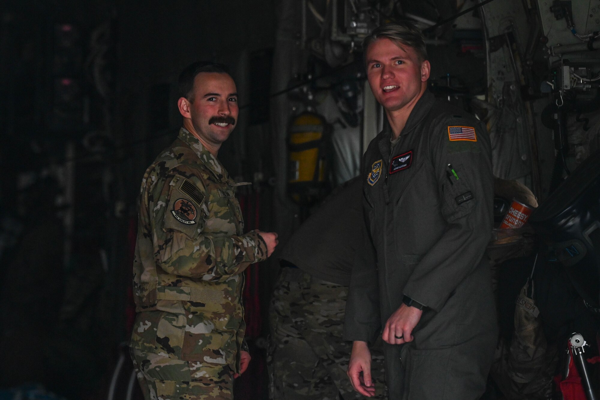 Two Airmen smile for a photo.