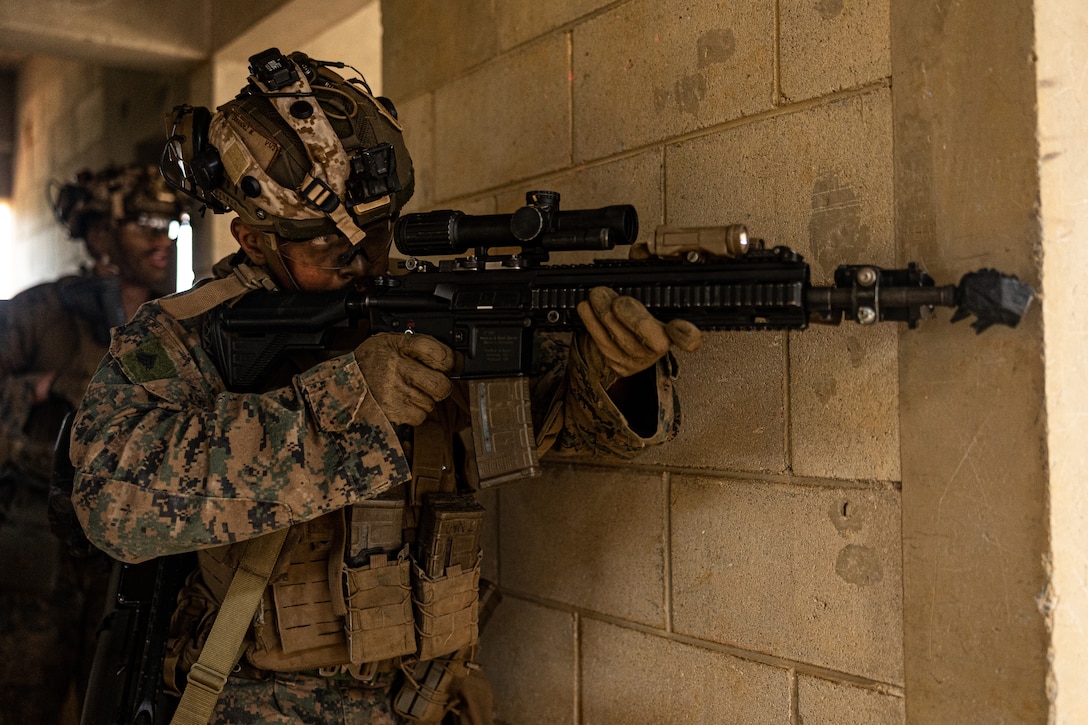 U.S. Marine Corps Cpl. Mario Fernandez clears a room during the 3d Marine Division Squad Competition at Camp Hansen, Okinawa, Japan, Jan. 24, 2024. The competition tested the Marines across various combat-related tasks to evaluate each squad’s tactical proficiency, mental and physical endurance, and decision-making skills to determine the Division’s most proficient and capable rifle squad. Fernandez, a native of Florida, is a rifleman with 3d Littoral Combat Team, 3d Marine Littoral Regiment, 3d Marine Division. (U.S. Marine Corps photo by Cpl. Eduardo Delatorre)