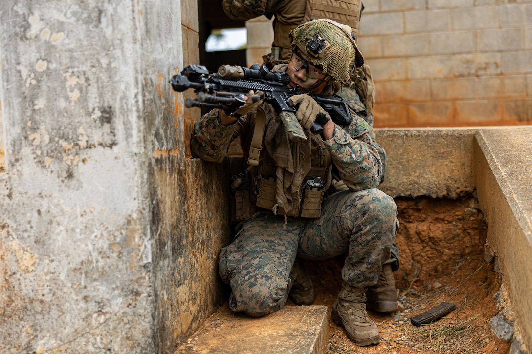 U.S. Marine Corps Cpl. Stephen Fuse posts security after clearing a building during the 3d Marine Division Squad Competition at Camp Hansen, Okinawa, Japan, Jan. 24, 2024. The competition tested the Marines across various combat-related tasks to evaluate each squad’s tactical proficiency, mental and physical endurance, and decision-making skills to determine the Division’s most proficient and capable rifle squad. Fuse, a native of Florida, is a rifleman with 3d Littoral Combat Team, 3d Marine Littoral Regiment, 3d Marine Division. (U.S. Marine Corps photo by Cpl. Eduardo Delatorre)