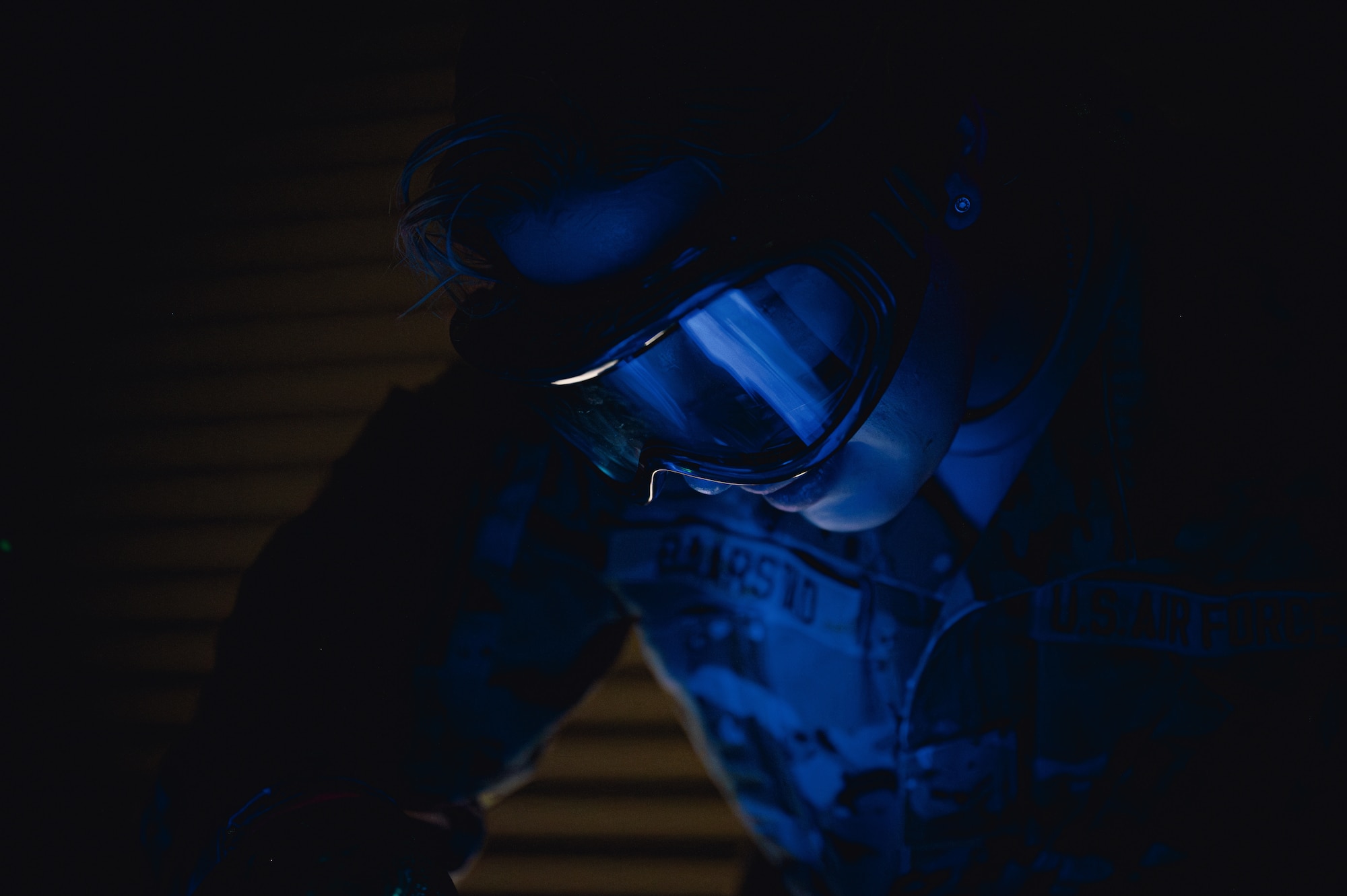 Military member inspects equipment.