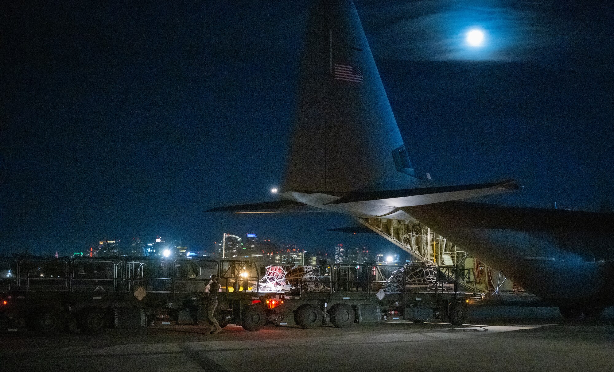 U.S. Air Force Senior Airman Alyssa Bradshaw, 732nd Expeditionary Air Mobility Squadron load team chief, deployed from Joint Base Elmendorf-Richardson, Alaska, directs cargo arrival from a C-130 Hercules during Exercise Bamboo Eagle 24-1 at Naval Air Station North Island, California, Jan. 26, 2024.