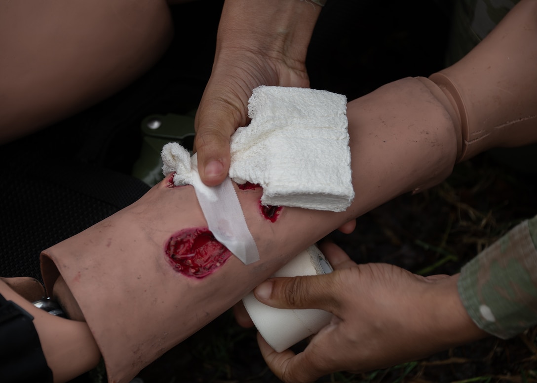 Members of the 316th Medical Group Ground Surgical Team perform tactical combat casualty care on a medical training mannikin at Joint Base Andrews, Md., Jan. 25, 2024.